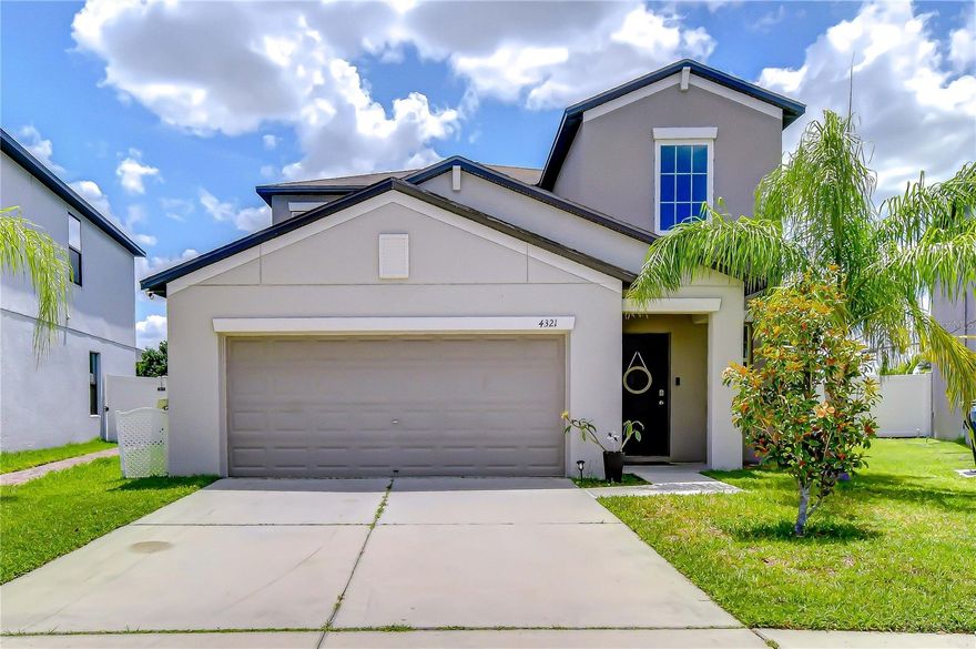 With over 2,400 square feet, 5 bedrooms, 2.5 bathrooms, and a thoughtful two-story layout, this newer-built home in a community with resort-style amenities delivers the kind of space, functionality, and value that’s hard to find at this price point. A soaring, full-height foyer welcomes you inside to an expansive open-concept design with a true central living space, seamlessly blending the kitchen, dining, and living area for effortless everyday living and entertaining. The well-appointed kitchen features abundant wood cabinetry with staggered-height upper cabinets, generous counter space, recessed lighting, a large center island with bar seating, and an oversized walk-in pantry that makes storage a non-issue. Tile flooring flows throughout the downstairs living areas, while French doors lead to a large, fully fenced backyard. The home is also equipped with a water softener, irrigation system, hurricane shutters, and the seller recently replaced the AC coil, offering added peace of mind. For optimal privacy, the primary suite is located downstairs creating true separation from the secondary bedrooms. The spacious retreat features wood-look ceramic plank flooring, an elegant chandelier, and an ensuite bath complete with a large walk-in closet, dual sinks, and a private water closet. Upstairs, a bright and versatile loft creates additional living flexibility alongside four spacious guest bedrooms, including two with walk-in closets. The full upstairs bathroom is conveniently positioned to all secondary bedrooms and is equipped with dual sinks and a separate tub/toilet room for maximum convenience and privacy. Beyond the home itself, Touchstone residents enjoy resort-style amenities including a beautiful community pool, clubhouse, fitness center, splash park, and playground, all just a short drive from downtown Tampa, and easy access to the Selmon Expressway, I-75, and I-4 to get you everywhere else. Low annual HOA fee and CDD is included in taxes. Newer construction, five bedrooms, and a Tampa address at an affordable price -- while most homes only check a couple of boxes, this one checks them all.