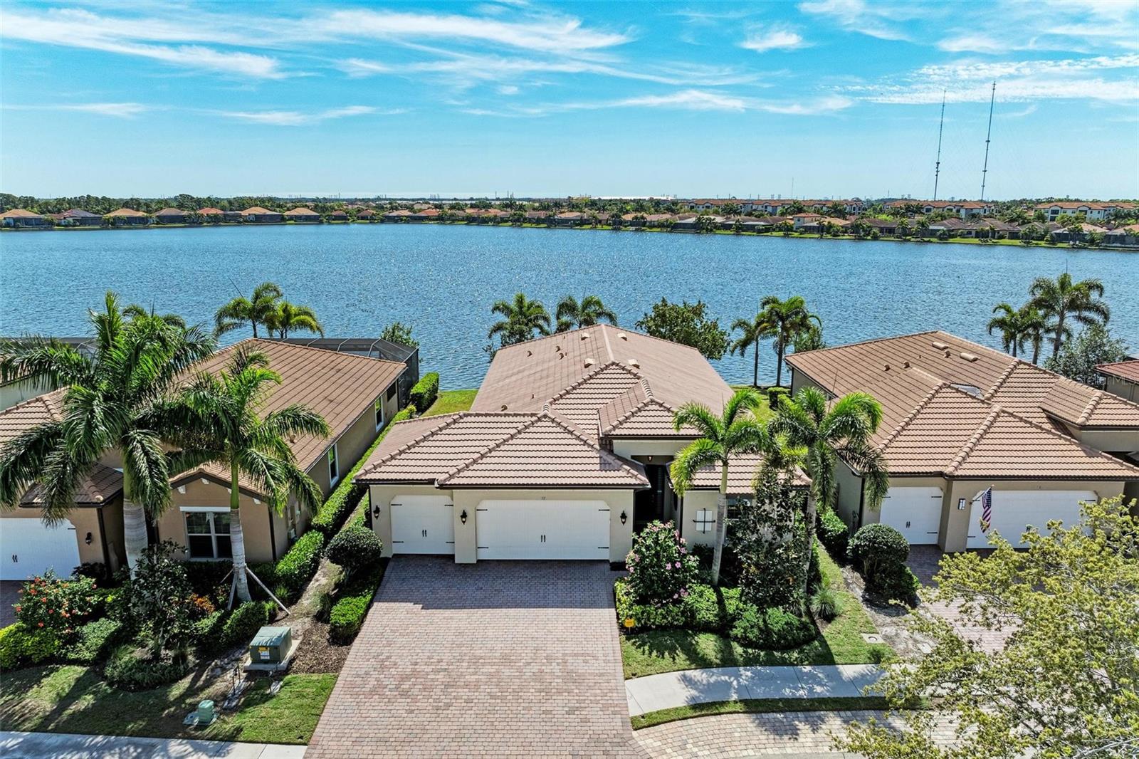 If you are ready to embrace a breathtaking water view at an incredible value, alongside low insurance premiums and minimal maintenance costs, look no further than this contemporary 4BR, 3.5BA estate home, complete with a den that is perfectly positioned on the 65-acre, sea-walled Lake Awesome. With its sought-after southeastern exposure, you will enjoy an abundance of natural light throughout the day. Imagine fishing from your backyard seawall, launching your kayak, or simply relaxing and soaking in the spectacular views. This property features striking long water views and sits on one of the highest elevation lots in the community at 15', which means there is no requirement for flood insurance. Built to modern building codes, the home is equipped with hurricane impact protection, resulting in low hazard and wind insurance premiums. This home includes an oversized 3-car garage, a lengthy driveway that accommodates multiple or long vehicles, a rear yard that can accomodate a large pool and spa - plan and estimate available, and a spacious side yard that is perfect for a dog run. This well-designed floor plan features a generous great room, an open dining area, and a kitchen designed to take full advantage of the breathtaking lake views and the radiant southern rear exposure that fills the space with shimmering light from the lake. The versatile floor plan can function as either a 4BR home with an open den or a 3BR with a formal office and an informal den, accommodating all your workspace needs. The contemporary design comes with upgrades such as a wave wall in the great room that creates the illusion of lake waves flowing into the space, elegant tray ceilings, 8' interior doors, extensive crown molding, high baseboards, designer light fixtures, custom window coverings including plantation shutters and Hunter Douglas shades, custom closets, tile floors, and wide-plank, hand-scraped sustainable Acacia hardwood floors in the bedrooms. The kitchen features Giallo Ornamental granite, light-glazed soft-close cabinets with 42" uppers, crown molding, a tumbled marble backsplash, under-cabinet lighting, a pantry closet with custom shelving, and upgraded stainless steel appliances, including a bottom-freezer French-door refrigerator, a slide-in range, and an exterior vented hood. Step out onto the outdoor lanai, adorned with a tongue-and-groove pine ceiling and a half bath, where you can overlook beautifully landscaped grounds, and delight in watching fish jump, turtles and ducks swim, or cormorants and ospreys dive for their next meal. The spacious main bedroom is designed for ultimate comfort, featuring large windows dressed with custom shades and blackout curtains, a tray ceiling, a Minka-Aire fan, and luxurious Acacia wood flooring. The en-suite bath is a private retreat, showcasing a large soaking tub, a roomy walk-in shower, designer listello, a chandelier, upgraded vanity lights, and a framed mirror. For those who prioritize security, this home includes a reinforced safe room closet to protect your loved ones and valuables. Plus, you are just a short stroll from the resort-style heated community pool and fitness center! Toscana Isles is a gated, maintenance-free community offering an array of amenities such as pickleball, tennis, kayaking, canoeing, and fishing across over 200 acres of interconnected lakes, all just 6 miles from Casey Key/Nokomis Beach, and very close to the new Sarasota Memorial Hospital Venice Campus.