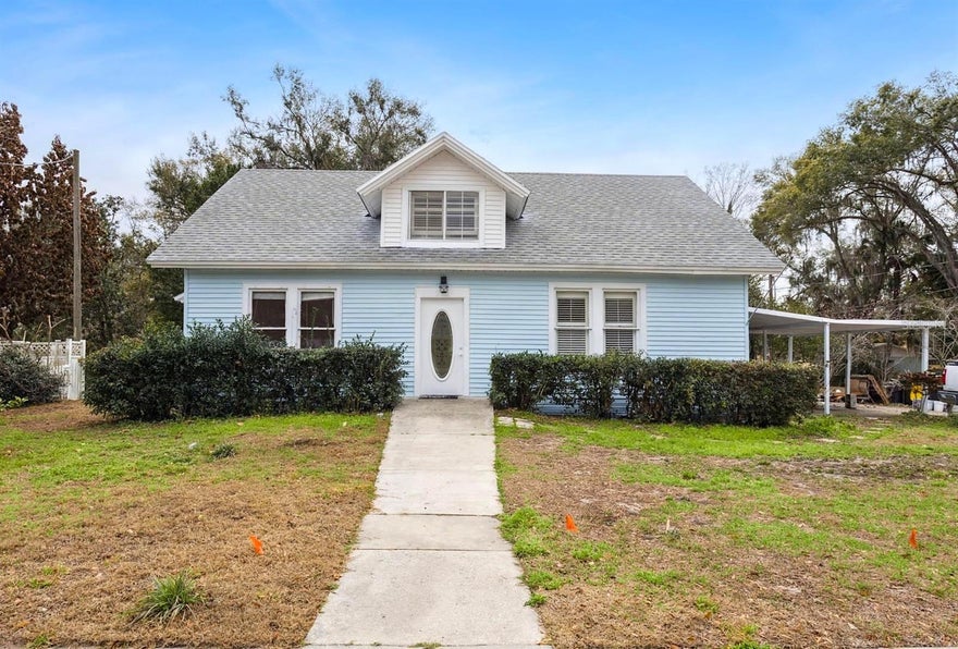 PRICE REDUCED and with RENT-TO-OWN option! Enjoy timeless charm and spacious living with this attractive, nearly 3,000 square foot, 5 bedroom, 4 bath home, blending timeless craftsmanship and character with the space and functionality you've been searching for. Featuring a NEW roof, NEW paint inside and out, NEW appliances! From the moment you step inside, you’ll be pleasantly surprised. The welcoming reception room just off the entry foyer makes a perfect home office, reading space, or creative studio. French doors open into a light-filled living room featuring a decorative fireplace that anchors the space with warmth and charm. The living room flows seamlessly into a generous dining area that comfortably accommodates a table for eight or more, creating an ideal setting for gatherings, celebrations, and everyday connection. The kitchen offers a delightful French country feel with open shelving and a generously sized pantry to accommodate cookware, small appliances, and your culinary essentials. The primary bedroom suite features travertine flooring, an en-suite bath, and its own private entrance that leads to a covered walkway and open patio. This outdoor space invites relaxation at the end of a long day and creates the perfect setting for quiet evenings under the Florida sky. Upstairs, you’ll discover an enchanting retreat complete with a spacious bedroom, full bath, and family loft area. Downstairs, three additional bedrooms provide ample room for family and guests, including a suite with its own private entrance and covered porch. The partially fenced yard offers space for gardening, play, or pets, all while maintaining minimal yard upkeep.  This lovely home is ideal for multi-generational living or potential income-producing opportunities. The location is equally impressive. Enjoy a walk to parks, the library, schools, and local restaurants, or a short bike ride or drive to Lake County Regional Park with walking trails, baseball and soccer fields, tennis courts, and a dog park. Umatilla is known as the "Gateway to the Ocala National Forest". Only twenty minutes to Mount Dora, thirty minutes to The Villages, fifty minutes to Orlando, and just about an hour to Daytona Beach. If you have been searching for space, character, craftsmanship, flexibility, price, options, and location all in one, this home delivers. Schedule your showing today!