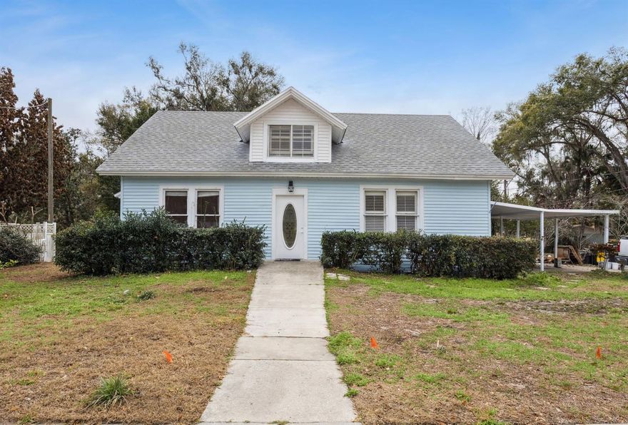 Timeless 1920s Charm Meets Modern Living in the Heart of Umatilla. Opportunities like this rarely become available in lovely Umatilla, Florida, the gateway to the Ocala National Forest. This spacious 5 bedroom, 4 bath home with so much space blends the craftsmanship and character of the 1920s with the space and functionality you've been searching for. From the moment you step inside, you’ll be pleasantly surprised. The welcoming bonus room / parlor just off the entry foyer makes a perfect home office, reading space, or creative studio. French doors open into a light-filled living room featuring painted hardwood flooring and a decorative fireplace that anchors the space with warmth and charm. The living room flows seamlessly into a generous dining area that comfortably accommodates a table for eight or more, creating an ideal setting for gatherings, celebrations, and everyday connection. The home is freshly painted inside and outside, and does need TLC here and there. The kitchen, featuring brand new appliances, offers a delightful French country feel with open shelving and a generously sized pantry to accommodate cookware, small appliances, and all your culinary essentials. It is both charming and practical, designed for real living. The primary bedroom suite is cozy and private, featuring travertine flooring, en suite bath, and its own private entrance that leads to a covered walkway and open patio with a fire pit. This outdoor space invites relaxation at the end of a long day and creates the perfect setting for quiet evenings under the Florida sky. The partially fenced yard offers space for gardening, play, or pets, all while maintaining minimal yard upkeep. Upstairs, you’ll discover an enchanting retreat complete with a spacious bedroom, full bath, and loft area. Whether used for guests, teenagers, crafts, gaming, or a creative escape, this flexible space adapts beautifully to your lifestyle. Back downstairs, three additional bedrooms provide ample room for family and guests, including a fully equipped in-law suite with its own private entrance and covered porch. The suite includes a full kitchen, living area with dinette, and a full bath, making it ideal for multi-generational living or potential income-producing opportunities. The location is equally impressive. You can walk to parks, the library, schools, and local restaurants, and enjoy a short bike ride or drive to Lake County Regional Park with walking trails, baseball and soccer fields, tennis courts, and even a dog park. You are approximately fifteen minutes to Mount Dora, thirty minutes to The Villages, fifty minutes to Orlando, and just about an hour to Daytona Beach. If you have been searching for space, character, craftsmanship, flexibility, and location all in one, this home delivers in every way. Schedule your showing today!