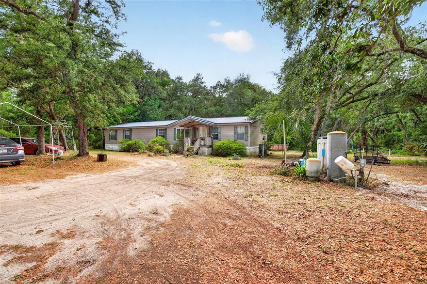 RARE FIND!   5 bed 3 bath home with solid plywood floors throughout!   Enjoy minimal neighbors as your property backs up to the GREENWAY & over 444 acres of FOREST!!    METAL ROOF 2014-- Fenced on 3 sides fence. Horse pasture/dog run.   Large wooden porch in back.  Shed for storage, 24 ft round 48 tall above ground pool with pump.  Chicken coop.  Wood burning Fire place . .