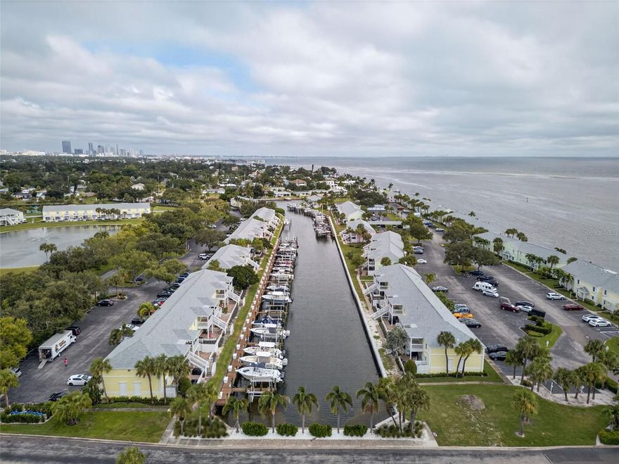 Welcome to the largest 1-bedroom condo floor plan in Waterside — an 823 sq. ft. second-floor waterfront unit with a 10K lbs BOAT LIFT, that perfectly blends comfort, style, and function. This tastefully updated condo features a bright, open layout, a modern kitchen with sleek finishes, and an updated bathroom with a beautiful walk-in shower. The spacious bedroom easily fits a king-sized bed and offers a large walk-in closet with a built-in storage system. The bonus room provides great flexibility — perfect for a home office, guest room, or additional closet space. Enjoy peace of mind with hurricane-impact windows and a new electrical panel.

A true boater’s paradise — this condo includes a 10,000-lb boat lift (installed in 2019) located directly behind the unit, offering quick and easy access to open water. With the boat lift included, this property delivers incredible value that’s hard to find anywhere else.
Enjoy pickleball courts, sand volleyball, a dog park, and a waterfront Yacht Club with regular social events. Your monthly HOA covers nearly everything — water, sewer, trash, cable, internet, and exterior maintenance — leaving only your electric bill to handle separately. Whether you’re relaxing on your balcony, watching dolphins play, or heading out for a sunset cruise, this is the perfect place to experience the true Florida lifestyle.
