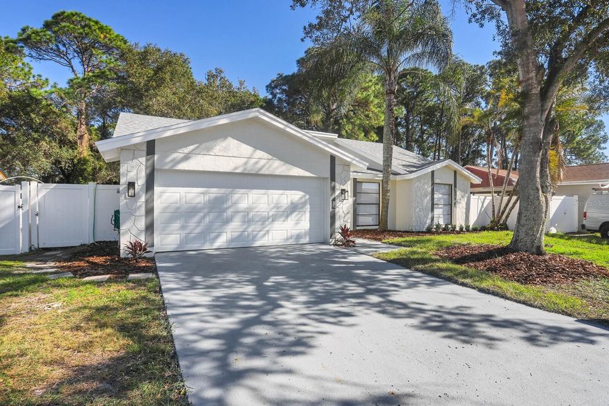 HELLO GORGEOUS! Welcome home to this COMPLETELY RENOVATED, SPLIT PLAN 3 bedroom, 2 bath home with a 2 car garage.  NEW ROOF, laminate flooring throughout, NO CARPET.  The kitchen features QUARTZ countertops, QUARTZ backsplash and NEW STAINLESS STEEL APPLIANCES.  Be WOWED by the FIREPLACE, the light and bright family room, along with the separate dining room. RECESSED LIGHTING throughout.  The Primary bedroom has its own bathroom with DUAL sinks, WALK-IN TILE shower and  a lot of closet space. Enjoy the backyard on the patio and a FULLY FENCED yard.  NO HOA, within minutes to shopping, 30 minutes to downtown Tampa, 40 minutes to the beaches. Schedule your showing today!