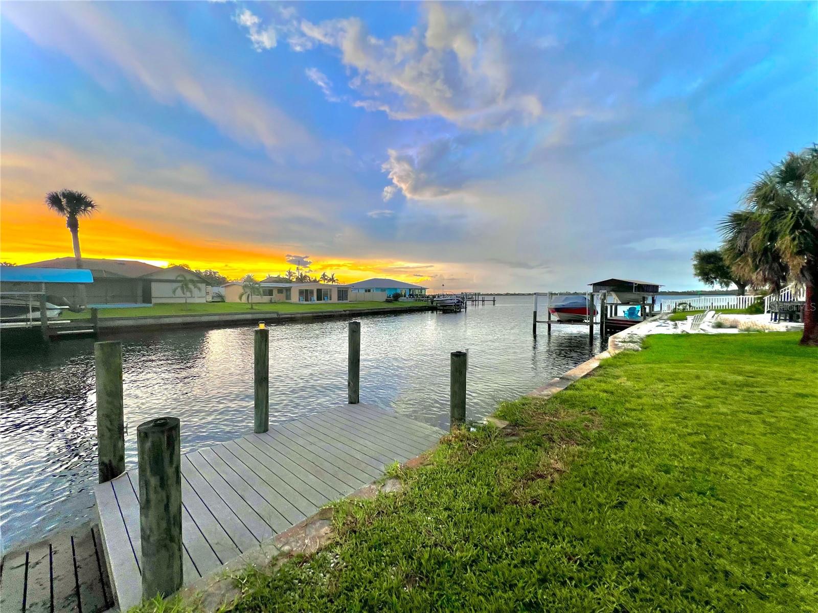 WATERFRONT, DOCK & SEAWALL. Enjoy your morning coffee watching the sunrise over the water or catching fish all day in this 4-bedroom, 2 bathroom home. Boating from your backyard to Gulf of Mexico, Myakka River, Punta Gorda and more. Improvements include 2023 New Roof, new AC, custom kitchen cabinets, granite, flooring, lighting, doors, painted interior and exterior & new siding. The kitchen has been completely remodeled and will be enjoyed with any size family or chef for entertaining in the large 26 x19 size. The master suite has amazing views of the water with a great wall for privacy to ensuite. The bonus room is 18x14 and can be used for additional storage, laundry room or make it an office/in-law-suite with a portable ac. Englewood Beach about 11 miles, Tampa Bay Rays spring training 6 miles, five public golf courses within 8 miles, Atlanta Braves spring training about 16 miles, shopping and restaurants about 3 miles. Per MLS- "25 foot bridge at high water." A must see home !!
