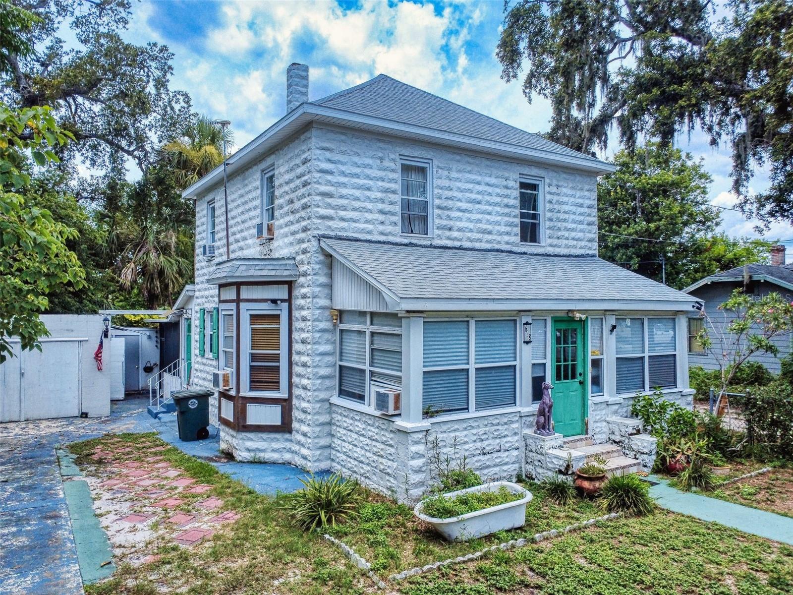 Welcome to a charming slice of coastal history just minutes from the sparkling sands of World-Famous Daytona Beach. This well-appointed, restored 2-bedroom, 2-bathroom home radiates timeless character, blending Old Florida charm with solid concrete construction and thoughtful efficient updates that include a new roof, added in 2021, and freshly painted interior making it move-in ready. From the moment you step into the bright enclosed front porch, with panoramic windows, it’s an ideal spot for sipping morning coffee, catching up with friends, or simply soaking in the neighborhood's beachside vibes. Inside, the spacious living room is filled with natural light thanks to a cozy bay window. The generous kitchen offers ample counter space for cooking and entertaining and offers updated appliances. High ceilings throughout the main level enhance the sense of openness and airiness, while upstairs, lovingly restored hardwood floors add charm and warmth. The additional loft space is perfect for reading, relaxing, or converting into a serene home office. Throughout the home, you’ll find original hardware and delightful details that speak to its storied past. Outside, the detached garage adjoins the laundry room and combines with a paver driveway to offer plenty of off-street parking. Situated just moments from the Daytona Beach Boardwalk, you’ll enjoy easy access to world-class dining, shopping, entertainment, and coastal adventure. This enchanting home is not just a place to live—it’s a place to feel inspired every day.