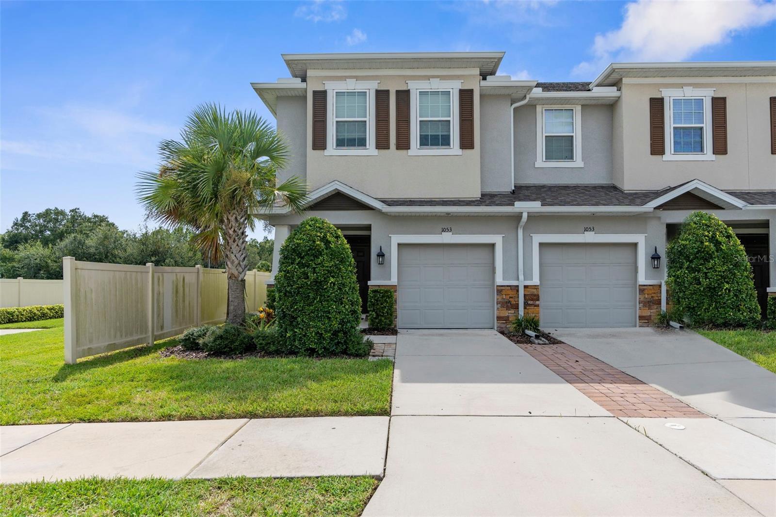 Welcome Home to WOODSIDE TRACE Townhome community located off Pasco/Hillsborough County Line. This END UNIT, 3 Bedroom, 2.5 Bathroom, 1 car-garage townhome is well maintained. LOW HOA!! NO CDD!! Water, Sewer, & Trash is covered in the HOA. Entering through the front porch you will immediately be impressed with the natural light that flows throughout the home, the recently professionally cleaned & sealed tile, and cleaned carpet. The main living area downstairs is tiled and consists of a well appointed kitchen with 42" cabinets with molding, walk-in pantry, subway tile backsplash, & stainless appliances, showcasing timeless style. The Kitchen is open to the dining room and living room allowing for a wonderful entertaining space. The slider off the living room leads to a large screened lanai. Half Bath is downstairs with natural light from the window. Upstairs you have the primary with a walk-in-closet and en-suite bathroom towards the back of the home with the additional two bedrooms and full bathroom towards the front offering privacy. The laundry closet is on the second floor. The location of the home is in close proximity to Wiregrass, The Tampa Premium Outlets, Medical, Restaurants, & Entertainment! Schedule your showing today!!