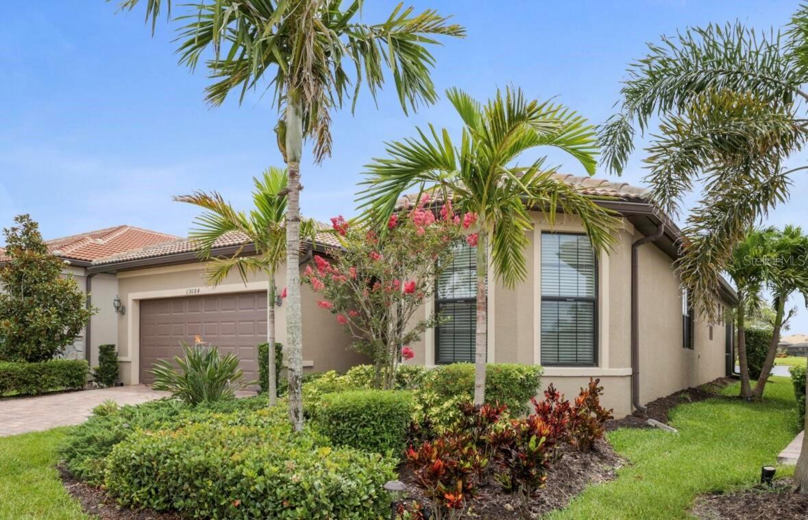Welcome to the stunning, fully furnished two bedroom, two bath ranch home with a den, located in the highly desirable resort community of Islandwalk. From the moment you enter through the newly installed leaded glass front door, you’ll be greeted by a light filled foyer and an open floor plan ideal for entertaining. This beautifully decorated home includes all furniture, decor, and accessories in the sale price, making it truly move-in ready. Interior features include extensive crown molding, 5 1/4 inch baseboards, an architectural accent wall in the family room, and upgraded tile flooring throughout the main living areas and baths. The gourmet kitchen is a chef’s dream offering upgraded cabinetry, quartz countertops, brand, new stainless steel appliances, and large pendant lights that add ambience and style. The spacious family room is filled with natural light, thanks to a trio of windows and a sliding glass door that opens to stunning water views. Ceiling fans grace the family room, and both bedrooms while a glass chandelier in the master suite. The large laundry room comes fully equipped with washer, dryer, and a walk-in pantry for extra storage.
Step outside to your private screened-in lanai where you can relax and enjoy Florida’s natural wildlife. A generous two car garage completes the package. living in Islandwalk means access to world class amenities, including two club houses, two resort style pools, pickleball, bocce ball, hard tru tennis courts, two fitness centers, and miles of scenic, walking, and biking trails. The community is golf cart friendly, and high-speed Internet, and cable TV are included in your HOA fees. Located just minutes from Cool Today Park, home of the brave spring training, and the many restaurants, shops, and events nearby Wellen Park. You’re also just a short distance from I 75, downtown Venice, and the beautiful Gulf Coast beaches. With its luxurious upgrades, unbeatable location, and included furnishings, this light and bright home offers an incredible opportunity to live the resort lifestyle every day.