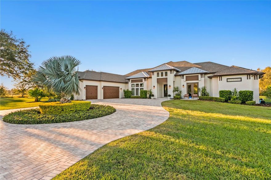 A true one-of-a-kind opportunity to own over 10 acres featuring a custom-built home, guest house, and two large barns. Nestled between Lake Frances and Lake Dan Nature Preserves and directly surrounded by untouched, protected ELAPP (Environmental Lands Acquisition and Protection Program) land, think of having over 3,000 acres of preserved land in your backyard, offering unmatched privacy and serenity.   Enter the property through a landscape of timber pine, lush grass, manicured landscaping and expansive skies overlooking protected land. The main home, set on just over five acres, is luxurious from the moment you enter with sweeping views of the pool and uninterrupted nature through multi-slide hurricane-rated doors. The open floor plan is ideal for daily living and entertaining, with a chef’s kitchen that boasts leathered granite countertops, an oversized island, wine refrigerator, ceiling-height custom cabinetry and a butler’s pantry equipped with a Thermador oven, dishwasher and sink. The primary suite is generously sized for a California King and features two walk-in closets with custom built-ins, along with a spa-like bath offering a soaking tub and a double-entry shower. All baths feature granite countertops and walk-in showers, with two of the four additional bedrooms offering en-suite layouts and spacious walk-in closets. Additional spaces include a custom office and a spacious interior laundry room with cabinetry and a garment-hanging area. The lanai is an entertainer’s dream or a place to unwind, complete with an outdoor fireplace, summer kitchen and privacy. The pool area offers resort-style relaxation with a sunning deck, spa, mineral filtration system and customizable lighting to set the mood for any occasion. The property includes a 20-stall barn with baths, storage rooms and flexible configuration for horses. Adjacent to the main home, the guest house sits on its 5.49-acre parcel. This 1,555-square-foot home features three bedrooms, two baths, a large patio deck and a two-car garage. A second barn is also on this parcel, complete with a large concrete pad for equipment, electrical and plumbing. Notable upgrades include full generator wiring, maturing pine trees that can be harvested for timber, and hurricane-rated windows and doors. Just a half mile from the Lake Dan Nature Preserve, with a playground, lake, sunset views and over five miles of equestrian trails, this special property is unlike any other. It is your chance to own a beautiful, one-of-a-kind luxury equestrian estate. Less than 20 miles from Tampa International Airport and just off Tarpon Springs Road in Odessa, it offers rare privacy without sacrificing convenience. Adjacent lot of guest home and barn are sold with this parcel.