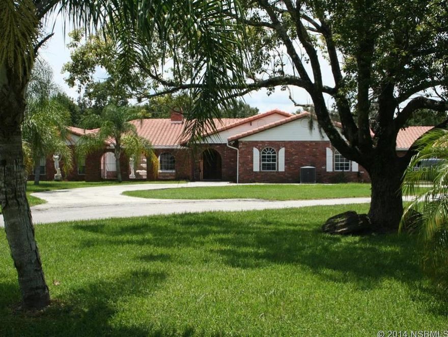 $45,000.00 Price Reduction...Unique Home on over 2 Acres in Spruce Creek Farms Subdivision...4 Large Master Suites with high quality Bathrooms with Granite Flooring...Newer Kitchen with Sub-Zero Refrigerator and 2 Double Wall Ovens...Large Fireplace and second Fireplace...Huge Family Room...Double Pane Windows...2 Storage Sheds...Pond...Horses Allowed.