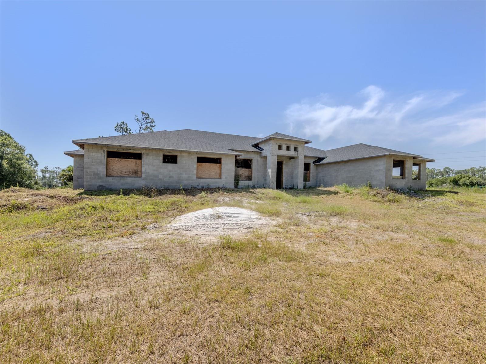 Under Construction. Investor, Builder & Homesteader Opportunity! Unlock the potential of this rare multi-dwelling property in the heart of booming North Port! Sitting on 2.25 acres (with an additional 2 acres available on a separate contract for a total of 4.25 acres), this unique offering features two homes ready for your finishing touch. The main home spans 3,137 sq. ft. under air with 5 bedrooms, 4 bathrooms, and a 3-car garage. The secondary home offers 899 sq. ft. under air, featuring 2 bedrooms, 2 bathrooms, and a 1-car garage—perfect for multi-generational living, rental income, or a guest retreat. While the seller will not complete construction, blueprints and drawings are included so you can bring your own vision to life. City water is paid for and available (not yet connected), and the multifamily zoning opens the door to a variety of possibilities—private estate, income-producing property, or investment development. Whether you’re an investor seeking strong ROI potential, a builder looking for your next project, or a homesteader dreaming of space and flexibility, this property offers endless opportunity in the desirable fast-growing area of North Port