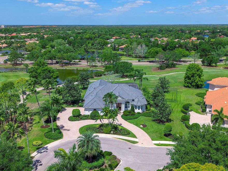 Set amidst a sprawling, cul-de-sac lot surrounded by lively golf course views within the desirable and upscale Portmarnock enclave of Lakewood Ranch Country Club is this stunningly upgraded residence.  Custom built and then thoughtfully upgraded throughout 2025-2020, this home is filled with luxe finishes and smart upgrades including new 2025 ROOF, 2023 whole-house GENERATOR, 2023 impact sliding glass doors and more.  Enjoy unparalleled privacy at the end of a quiet cul-de-sac with a 0.6-acre lot, no neighbors on the left side of the home and true side, exterior loading 3-car garage with expansive circular driveway.  This desirable lot is perfectly situated on holes 17 and 18 of the Cypress Links course.  Modern enhancements include newer interior and exterior paint, upgraded wood-look porcelain plank tile flooring, designer light fixtures and fans, plantation shutters, added moldings and trim, along with elevated finishes in the kitchen and bathrooms.  This classic floor plan comprises of over 3,600 SF of flexible living spaces including both formal and casual entertaining areas plus separate den and bonus room.  The double door entry leads to an expanded foyer trimmed with modern square columns and custom wainscoting and opens into the formal dining room with upgraded wet bar.  The formal living room offers a cozy place to gather by the stone fireplace, display shelves and pocketing impact sliding glass doors so the gathering can seamlessly spill out onto the lanai.  The expansive paver lanai showcases golf course views through a completely refurbished lanai pool cage with clear views and a partial colonnade. Cherish sunny afternoons lounging on the deck, cozy evenings gathered by the fireplace, barbeques at the outdoor grill, splashing in the pool or relaxing in the spa. Four-legged family members will have the run of the expansive back and side yards all enclosed with fencing. The open kitchen is where family and guests will gather around the outer island with quartz counters to watch the chef at work amongst abundant storage cabinetry, central prep island, marble backsplash and expansive walk-in pantry. Enjoy meals prepared in this spacious kitchen with stainless steel appliance suite including a gas cooktop and new 2026 refrigerator. Casual weeknights are enjoyable in the dinette framed by aquarium windows and golf course views. The family room includes custom wainscoting, built-in entertainment center and pocketing impact sliding glass doors to the lanai. Your primary oasis offers a double step tray ceiling, large windows overlooking the golf course with plantation shutters, impact sliding door to the lanai and plentiful storage options with two walk-in closets plus another built-in closet. The en-suite bathroom showcases splendid renovations with modern freestanding tub; impact glass windows, frosted privacy-glass enclosed walk-in shower with elevated porcelain tile and long vanity with dual sinks. Guests will find comfort in two guest suites with bay windows and a full bathroom off the private hallway. The bonus room with built-in closet offers dual function as a 4th bedroom and has an adjacent full bathroom that is also a pool bath. Additional spaces include a private study and laundry room with 2026 washer and dryer. Appreciate a state-of-the-art fitness center, clubhouses, junior Olympic-sized pool, four 18-hole championship golf courses, tennis and pickleball and more by becoming a member of the Lakewood Ranch Country Club.