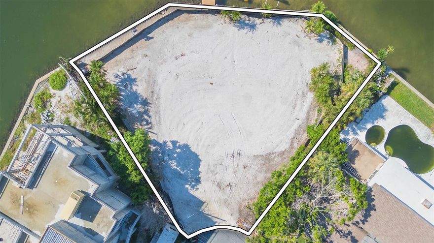 Reduced to Sell!  Seize this rare opportunity to own a prime waterfront property in the highly desirable St. Pete Beach community. This 10,441 sq. ft. lot boasts over 165 feet of open water frontage, offering breathtaking views that are unmatched in the area. Featuring a newer seawall and a deep water dock, this property is perfect for those who dream of coastal living with direct water access. It presents the perfect blank canvas for a new homeowner to design and build a personalized masterpiece from the ground up. Just steps away from pristine beaches, exceptional dining, and year-round vacation vibes, this property is truly a slice of paradise with immense value and potential.