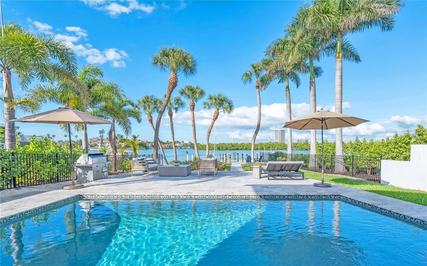 An Exquisite Bayfront Residence on Prestigious Lido Key, Sarasota. This meticulously reimagined two-story bayfront masterpiece embodies the pinnacle of sophisticated coastal living. Offering 3,832 square feet of thoughtfully designed interior space which was fully renovated in 2017, including impact-resistant doors and windows and a new roof. The residence features 4 ensuite bedrooms, a state-of-the-art 2025 gourmet kitchen, designed for discerning entertainers, showcases premium appliances, custom cabinetry, and an expansive island that serves as the heart of the open-plan living areas. The new elegant flooring unifies the bright, voluminous interiors. The second story includes a spacious home office with views over the pool to the bay. Beyond the interiors lies a private waterfront sanctuary: a heated saltwater pool overlooks an expansive floating dock, ideally suited for vessels of varying sizes, kayaks, or paddleboards. Unobstructed sailboat access invites effortless exploration of the bay and beyond. Additional conveniences include a spacious two-car garage, proximity to downtown Sarasota's vibrant cultural scene, a 15-minute drive to Sarasota-Bradenton International Airport. Close by is the pristine sands of Lido Beach with the most spectacular sunsets and moments away is St. Armands Circle's dining and shopping. Framed by the preserved mangroves of Otter Key, the sheltered waters host an abundance of marine life, dolphins, manatees, and graceful wading birds frequently enchant residents with their presence. This extraordinary property represents a rare harmony of tranquil waterfront serenity, impeccable modern enhancements, and unparalleled proximity to Sarasota's finest amenities—an enduring legacy of refined coastal elegance.