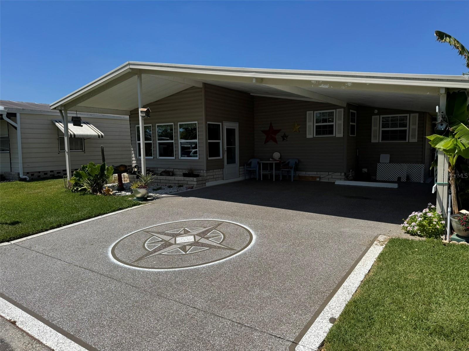 MINT CONDITION, well-kept home in the highly desirable, Timber Lake Estates. The home maintains a comfortable 10x11 Florida Room. A priceless sun-guarding 2-Car Carport. Additionally, the home provides a 10x30 workshop that will impress anyone that enjoys a "Do It Yourself" project. Timber Lake is a resident owned, gated community that is not age-restricted. The very reasonable monthly HOA includes water, exterior maintenance along with 2 clubhouses with pools and a lake stocked with fish. The community holds many social events including bingo, line dancing and many more. Conveniently located near Publix, Home Depot and State Rd 56 leading to Wiregrass Mall, Costco and the outlet mall.