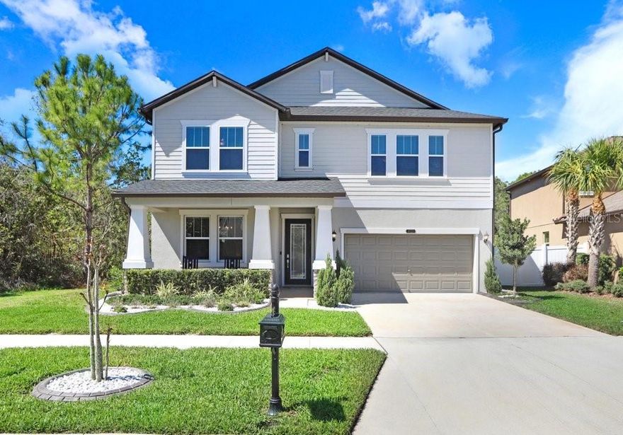 Stunning two-story home in the sought-after Connerton community! This beautifully upgraded 5-bedroom, 3.5-bathroom home with a 3-car tandem garage features a spacious open-concept design, perfect for modern living. Situated on a premium pond/conservation lot, just a few steps from the clubhouse. The first-floor primary suite offers a walk-in closet, tray ceilings, and a spa-like ensuite with a dual vanity, resort-style walk-in shower, and soaking tub. This home features TWO LAUNDRY ROOMS for your convenience, one on the first floor next to the master suite, and another on the second floor. "The chef’s kitchen is designed for functionality and style, boasting an extra-long quartz island, gas stove, walk-in pantry, quartz countertops, and backsplash. Enjoy seamless indoor-outdoor living on the screened lanai, offering breathtaking views of the conservation area and pond. Upstairs, a spacious bonus room provides endless possibilities for a home office, media room, or play area, along with the main laundry room, four bedrooms and two full bathrooms. There is a secondary laundry on the first floor. Recent upgrades include quartz countertops, upgraded kitchen appliances and sink, a fully fenced backyard, crown molding, trendy custom wood accent wall panels throughout the first floor and staircase wall, a custom TV wall with shelves, stylish stone accents, and a fireplace. Additional enhancements include gutters, upgraded landscaping, a water softener with reverse osmosis and alkaline filter, and all first-floor tile flooring. This section of Connerton has NATURAL GAS and Reclaimed Water. The community is zoned for top-rated schools and offers resort-style amenities, including a pool with splash park & slide, a 10,000 sq. ft. clubhouse with a café & fitness center, tennis, basketball & volleyball courts, scenic nature trails, and a playground. Don’t miss this move-in-ready home in a vibrant, amenity-rich community! Schedule your showing today!