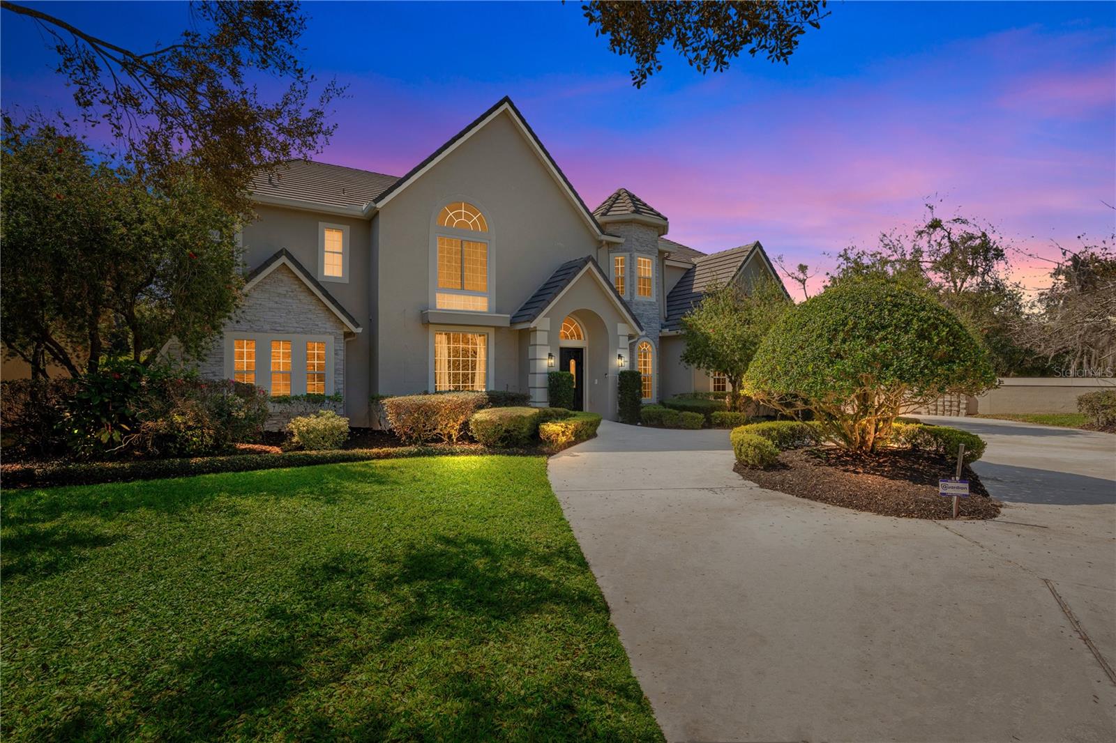 WATERFRONT CANAL ESTATE | DR. PHILLIPS Welcome to your luxury living opportunity on the Butler Chain of Lakes. Arrive at the convenience of a 24-hour guard gate before witnessing the verdant beauty of this magnificent neighborhood. This majestic canal front home is nestled inside the desirable Turtle Creek community of Dr. Phillips. The location of this home is just one of the countless details that separate it from anything else on the market. It privately lies at the end of a cul-de-sac on a 1/2-acre+ lot. As you pull into the long wraparound driveway to a four-car garage, you are immediately immersed into a serendipitous landscape. This home is planted at the edge of a canal, providing you not only waterfront privacy but also direct access to the Butler Chain Of Lakes. Equipped with a covered electric boat dock, allowing lake enthusiasts full access to everything the Butler Chain has to offer. Upon entry, an elegant foyer with 20+ foot high ceilings takes you past a separate family room to the left and formal dining to the right. Continuing, you will witness an open floor plan that simply spells perfection. A large great room fitted with a wet bar is merged with a phenomenal kitchen and dinette, offering spectacular views to your spacious and enclosed pool area. Downstairs, a 2nd master bedroom was converted into a custom gym with mirrors and proper gym flooring. If working out isn't on the menu, this room can be easily transformed into a spacious in-law suite/2nd master bedroom. A formal office and large laundry complete the extensive downstairs living space. Make your way up the lovely staircase to the 32' catwalk connecting four additional oversized bedrooms and a master suite. If you like to entertain, look no further. The lanai enclosed pool has a turtle like design and is absolutely stunning. The outdoor patio is fitted with a summer kitchen and the total space is grand enough to host large gatherings and ideal for entertaining. Enjoy all the conveniences to the Dr. Phillips lifestyle, plus just minutes away from top-rated schools, Restaurant Row & all of the Disney/Universal/SeaWorld theme parks. It is no surprise why owning a home in Turtle Creek is truly extraordinary.