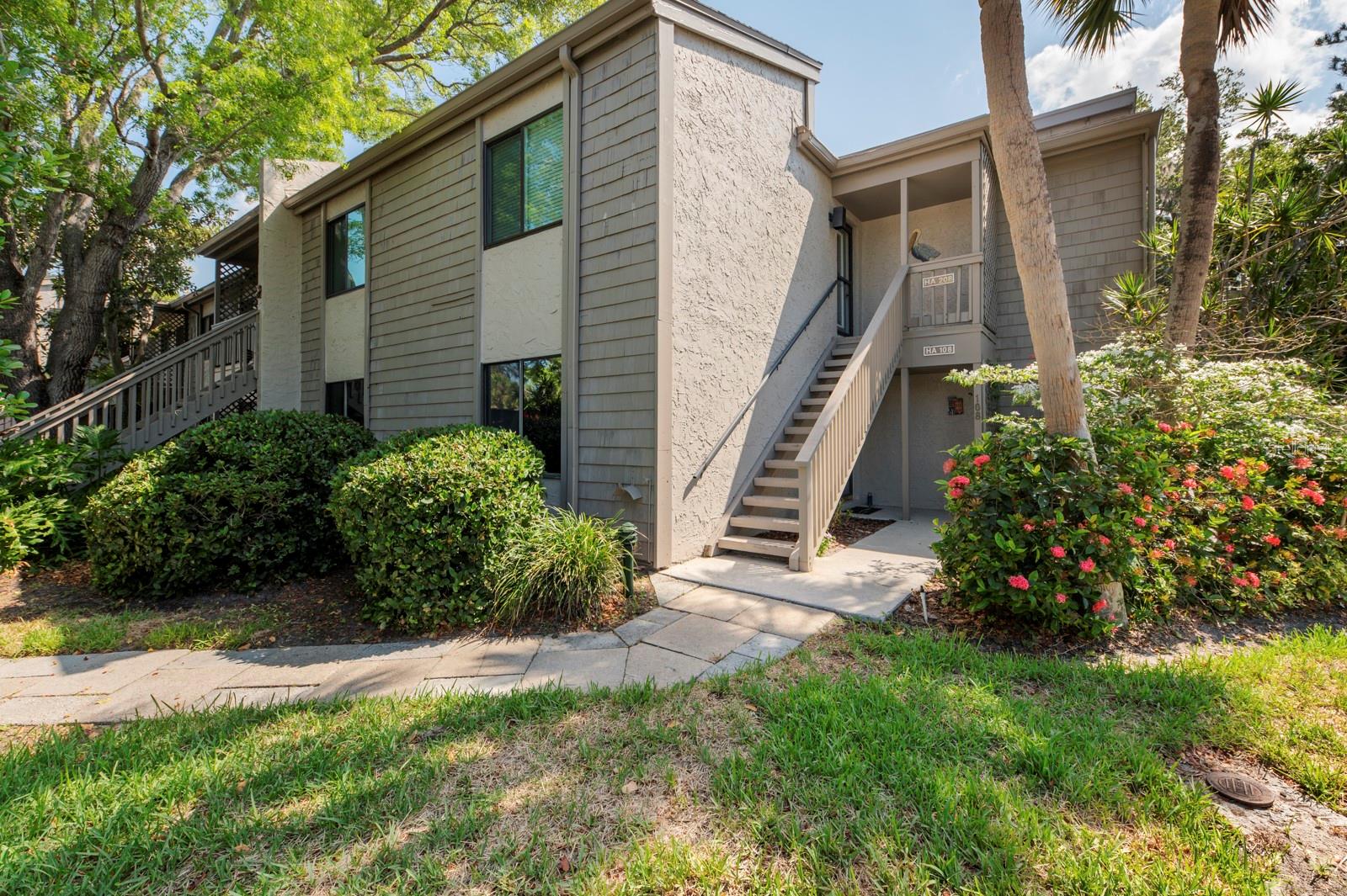 This ground floor condominium is a three bedroom plus a DEN with stunning views of Pelican cove harbor and is nestled under a canopy of oak trees with storybook views on a point surrounded by the harbor. The open floor plan with the sunny & bright Florida lanai room boasts loads of storage in and out. This condo is centrally located within Pelican Cove, one of Sarasota's most popular gated, waterfront complexes. It's a short walk from the front door to the most picturesque of the six heated pools, or to the serene deck at Pelican Point to watch the sun set over the bay. Pelican Cove is spread out over 75 acres of natural beauty, built along Sarasota Bay. Pelican Cove has to be seen to be appreciated with manicured tropical foliage, tennis courts, 6 pools, exercise room and workshops of all kinds. Activities of every type are present: Art, Music, Wood working, Boating, and Fitness & Pelican University, kayaking, fishing, 6 pools, 4 tennis courts, a private harbor and numerous clubs and activities. Additional storage has been added to this condo for new owners' convenience. Pelican Cove is spread over 75 acres and amenities include/gated community of botanical setting on Little Sarasota Bay, within a gated community that offers sailboat, canoe, kayaking & fishing 6 pools, 4 tennis courts, a private harbor and numerous clubs and activities.