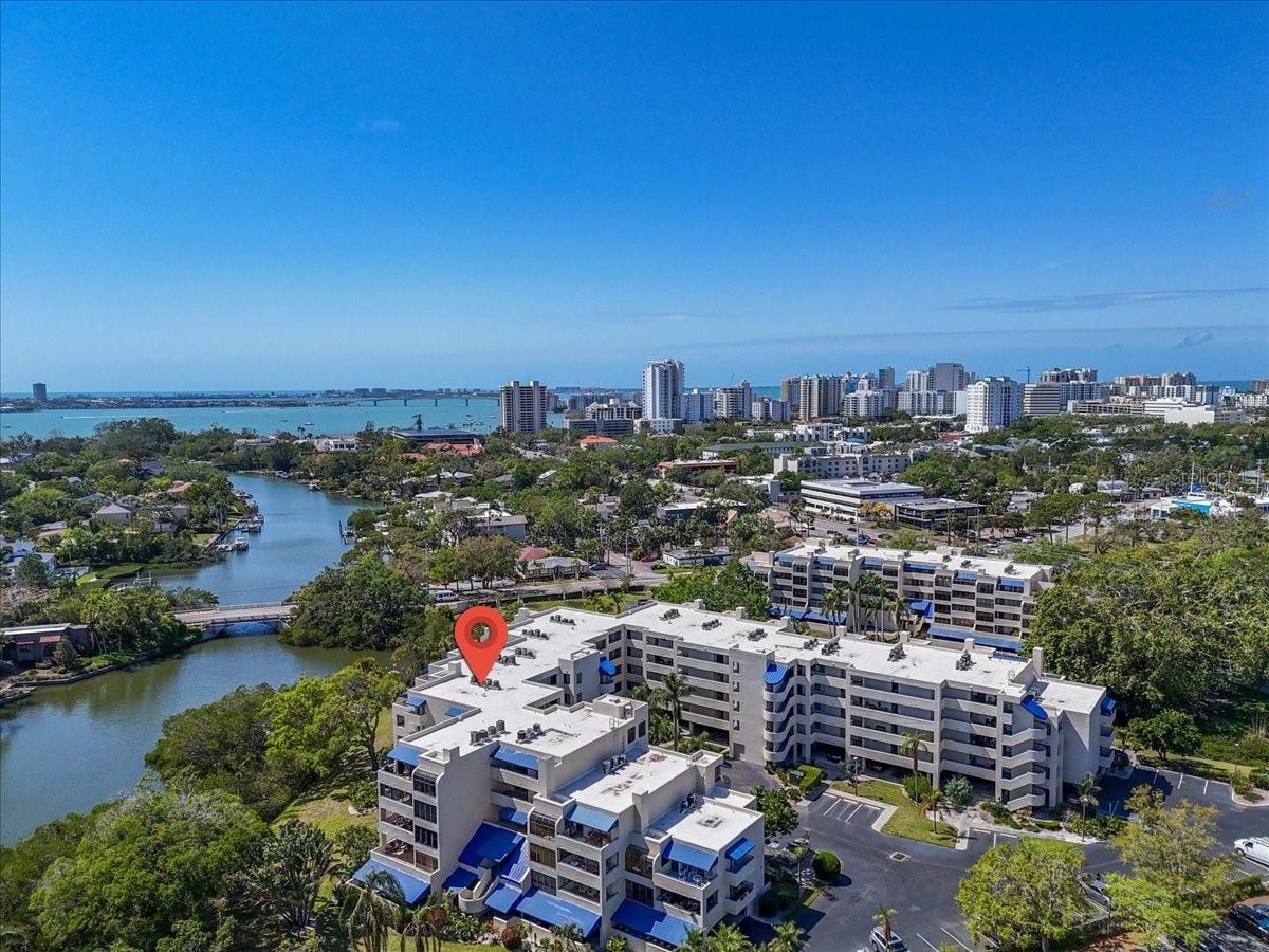BE CENTER STAGE AND LIVE AT THE HEART OF SARASOTA IN THIS TOP FLOOR UNIT! This is the definition of LOCATION, LOCATION, LOCATION! Walking distance to the vibrant day and night life of downtown Sarasota, or ride your bike to the top ranked beaches in the nation! Need an airport nearby? Check that box here, too. From cultural experiences such as the Sarasota Art Museum (about a block away), renowned Ringling Museum, and Marie Selby Botanical Gardens (just around the corner), to both fine and casual dining options, and fabulous shopping, you'll never be bored. Between downtown, St. Armand's Circle, and of course Siesta Key, you can choose your own adventure and never run out of exciting things to do. This ideally situated TOP FLOOR unit (across from the elevator for exceptional convenience) features 1 large bedroom with French doors to a private balcony, an ensuite bathroom and walk-in closet. The main living area has a light-filled living room and French doors accessing the balcony with stunning water views adding to the peacefulness of the home and plenty of room for outdoor furniture to suit your taste. The kitchen overlooks the living room, has granite counters, a washer and dryer unit, and cozy breakfast nook. The bathroom has a shower/tub combo and is accessible from both the living room hallway and the bedroom. NEW AC in 2024, and no hurricane damage! This very tranquil community features a large community pool, covered parking, elevator access, kayak launch, and pier with access to the Hudson Bayou and beyond. Priced to sell so you don't have to stress over waiting for the right deal to come along...this is it! Schedule your private showing and enjoy all that Central Park living has to offer.