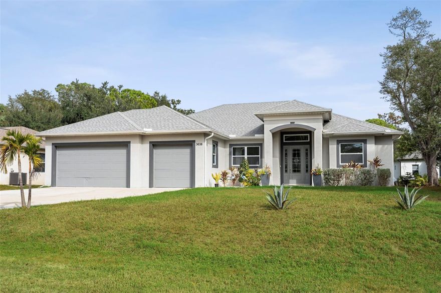 LOCATION! LOCATION! LOCATION! Modern 2023 Custom-Built Home with Independent Lanai Suite  and Mother in Law unit – 3 Bed / 3.5 Bath + OFFICE, 3-Car Garage  in North Port, FL.
Discover refined contemporary living in this beautifully crafted 2023 custom-built home located in the heart of North Port, Florida. This stunning property offers 3 bedrooms, 3.5 bathrooms, a 3-car garage, a dedicated office, and an independent screened, covered lanai suite complete with its own full bathroom and kitchen—perfect for guests, extended family, or rental flexibility.
Step inside to soaring high ceilings, expansive sliding glass doors, and hurricane-impact windows and doors that enhance both safety and natural light. The open floorplan seamlessly connects the spacious living area to the designer kitchen, featuring stainless steel appliances, a sleek range hood, abundant cabinetry, and a convenient coffee station.
The home includes two bedrooms, a full bathroom, and a kitchenette—ideal for use as a mother-in-law suite, multi-generation living, or a private guest wing.
The primary home also offers a well-appointed laundry room with cabinets and a sink, luxury vinyl flooring throughout the main areas, and modern tile flooring in the bathrooms.
Outdoors, you’ll find an oversized paved driveway, attractive landscaping, and a useful storage shed in the backyard. Best of all—No HOA/ CDD!!! NO FLOOD INSURANCE REQUIRED! NO HOA and No CDD fees, providing freedom and peace of mind. This house is Conveniently located on a street with new homes around very close to I-75, shopping, dining and many local beaches. Also located in North Port close to several schools and a short car ride away from Centennial Park and Pool as well as a variety of dining and shopping options including Cocoplum Shopping Center. Take advantage of all the area has to include multiple golf courses and TWO Major League Baseball Spring Training stadiums! Within 15 minutes drive you can be at WELLEN PARK, the new Atlanta Braves Training Stadium, Cool Today Park, and the highly anticipated new Costco store!!! Close to shopping, restaurants, and River. Within 25 minutes drive , you can be at Manasota Beach on the Gulf of Mexico, Aquatic Center, and much more.  Call now to schedule a showing before this home passes you by!!! This home blends style, comfort, and versatility in one premium location. A true gem in North Port!!!