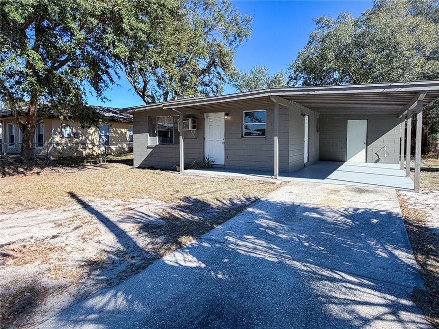 This beautifully updated 3-bedroom home offers a fresh, modern feel throughout with luxury gray wood-look vinyl plank flooring and a full interior refresh including new paint on ceilings, walls, and trim. Each bedroom features a brand-new  ceiling fan and its own dedicated A/C unit for added comfort. The kitchen is equipped with brand-new matching GE appliances including refrigerator, stove, and microwave, and the home is filled with natural light from two large living room windows plus an additional kitchen window. The bathroom has been completely renovated with a new vanity, new toilet, updated shower surround, modern waterfall-style shower head, and new tile flooring. Enjoy the spacious covered porch, covered carport, and the convenience of a separate laundry room. Home also includes a brand-new 40-gallon A.O. Smith electric water heater.