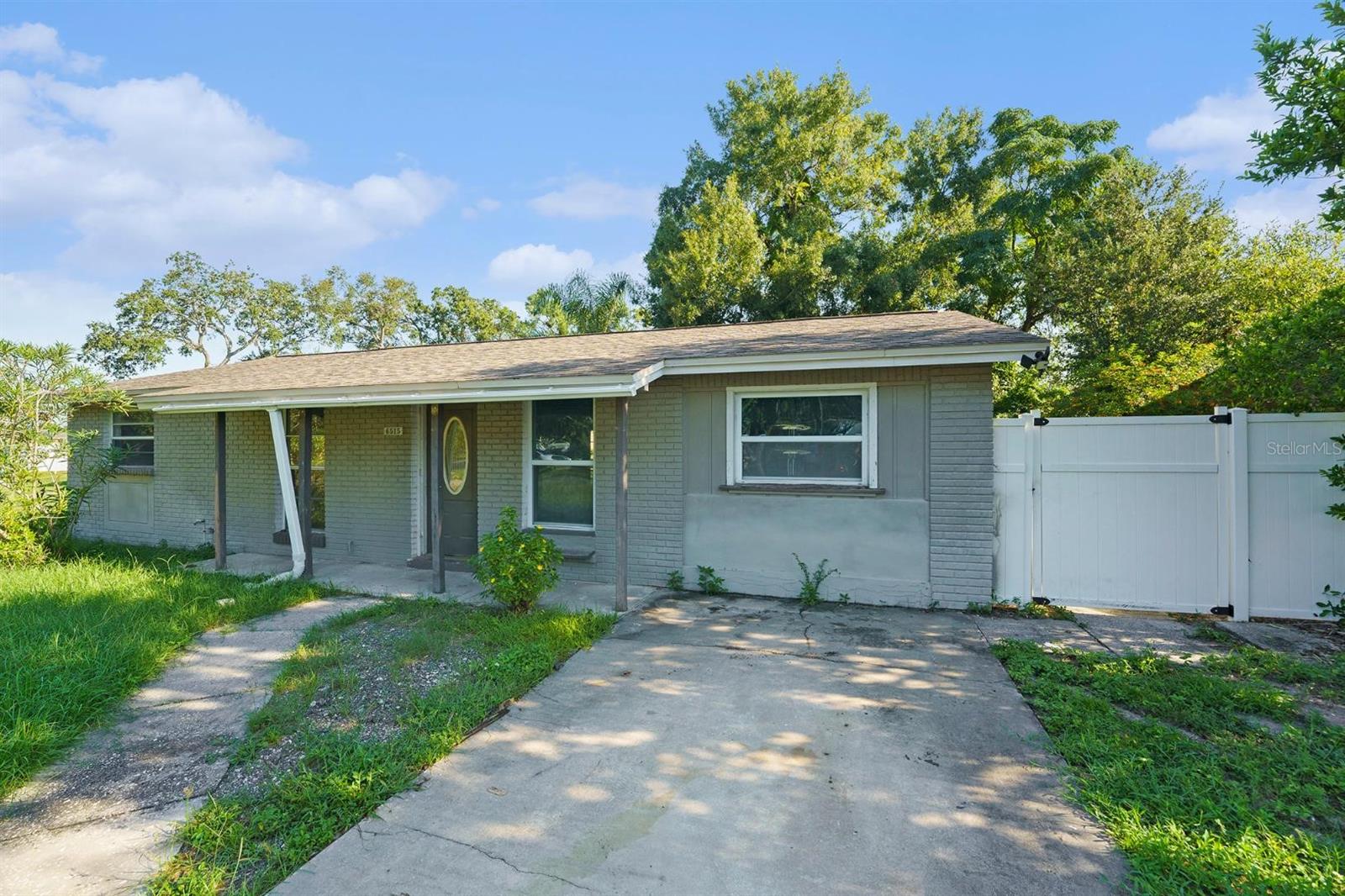 Check out this solid ranch home centrally located in Town 'N Country on a large, pie-shaped, fenced lot. A key feature of this property is the additional dwelling unit (ADU) located in the backyard, which includes a full bath and kitchen, offering great flexibility. The main home itself has an updated kitchen with new cabinets, quartz countertops, and recessed lighting. The flooring consists of luxury vinyl in the common areas and new carpet in the three bedrooms. There's an open dining area that flows into the family/living room, and French doors lead out to a covered rear porch and an oversized fenced yard with an additional storage shed. In terms of location, it offers convenient shopping, is close to bus lines, and just minutes from the Veterans Expressway.