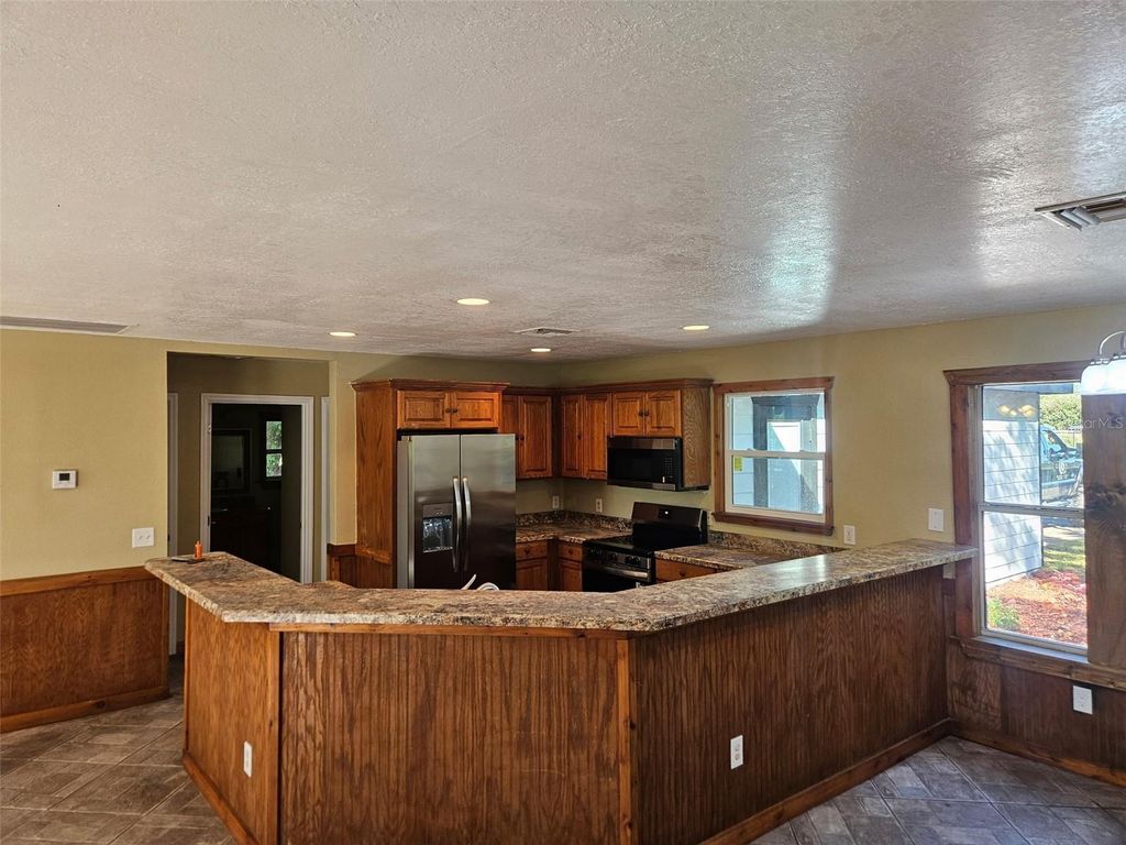 Photo of 12022 SE Sunset Harbor Road, Weirsdale, FL 32195 (MLS # R4910092)