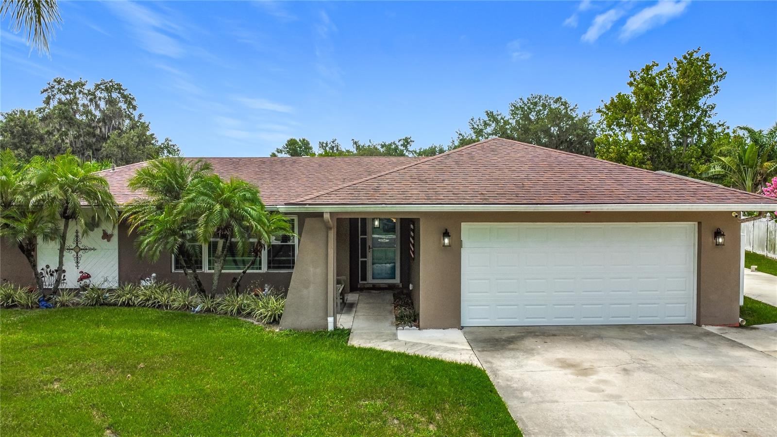 Welcome to HARBOUR OAKS – a sought-after community known for its spacious lots, charming custom homes, and canopy of beautiful mature trees. Nestled on a quiet cul-de-sac, this meticulously maintained 3-BEDROOM, 2-BATH POOL HOME sits on a fully fenced .32-acre lot with an extended driveway and room to spread out. Step inside to find stylish wood-look tile flooring throughout (no carpet!), a fully updated kitchen featuring granite countertops, tile backsplash, stainless steel appliances including a built-in double convection oven and cooktop, plus a pass-through window to the lanai and breakfast bar—perfect for entertaining! Enjoy year-round relaxation on your lanai overlooking the heated saltwater pool, all fully screen enclosed. The spacious primary suite boasts a walk-in closet and spa-inspired en suite bath. Two additional guest bedrooms offer flexibility, one of which includes its own walk-in closet. Additional features include an inside laundry room with washer, dryer, utility sink, and extra storage. Need space for projects, toys, or tools? You'll love the 20x40 detached metal building—fully insulated, with electric, a 2-ton mini split, and 10-ft roll-up door. This home has been lovingly maintained by the same owner for over 22 years. Recent improvements include a new roof (2017), double-pane windows, updated kitchen and baths, new garage door, and GE Profile stainless steel appliances. The pool heater and filtration system were replaced in 2020, and the salt system in 2025. Energy efficiency shines with blown-in attic insulation and consistently low electric bills. Move-in ready and beautifully cared for—this one is a must-see!