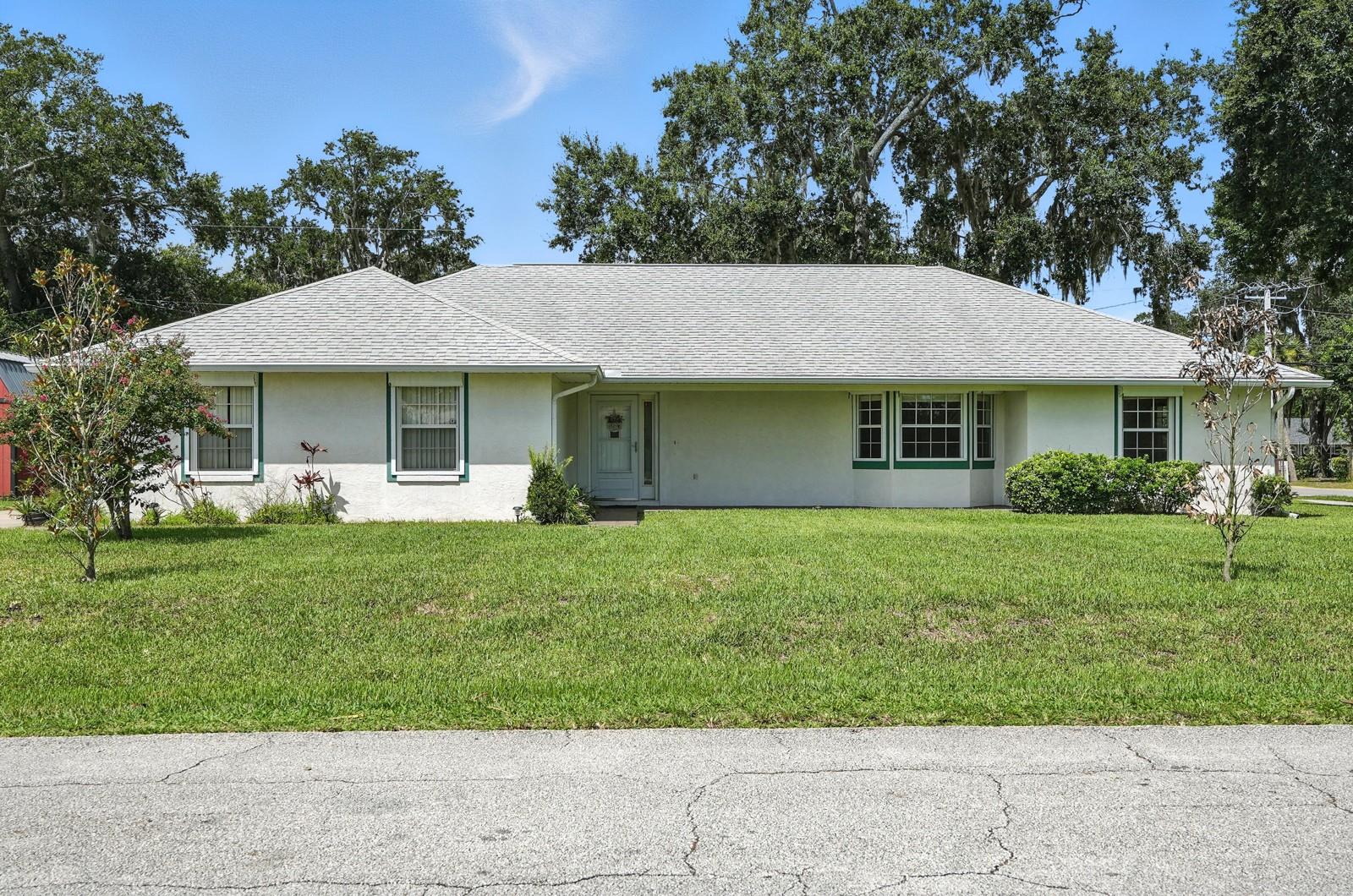 High and Dry – Not Affected by Recent Hurricanes!
This beautiful corner lot home on sought-after 30th Street in Florida Shores offers peace of mind, comfort, and the perfect Florida lifestyle. Featuring vaulted ceilings, neutral paint colors, a split floor plan, and open concept living areas, this home is open, airy, and move-in ready.
The primary suite includes a large walk-in closet and a bathroom with a relaxing jacuzzi tub and separate walk in shower. You’ll love the convenience of an indoor laundry room and a spacious 2-car garage with extra workspace and a screened garage door. Plus, enjoy the enclosed back porch—perfect for relaxing or entertaining.
Sidewalk-lined street nearby make walks to Whistle Stop Park enjoyable and convenient, and you’ll have a front-row seat to the Edgewater Christmas Parade right from your own yard!
Only 9 miles to New Smyrna Beach and 17 miles to world-famous Daytona Beach—ideal for surfing, sunbathing, and waterfront dining. You’re also just a few miles from the Indian River, offering fishing, kayaking, boating, and more outdoor fun.