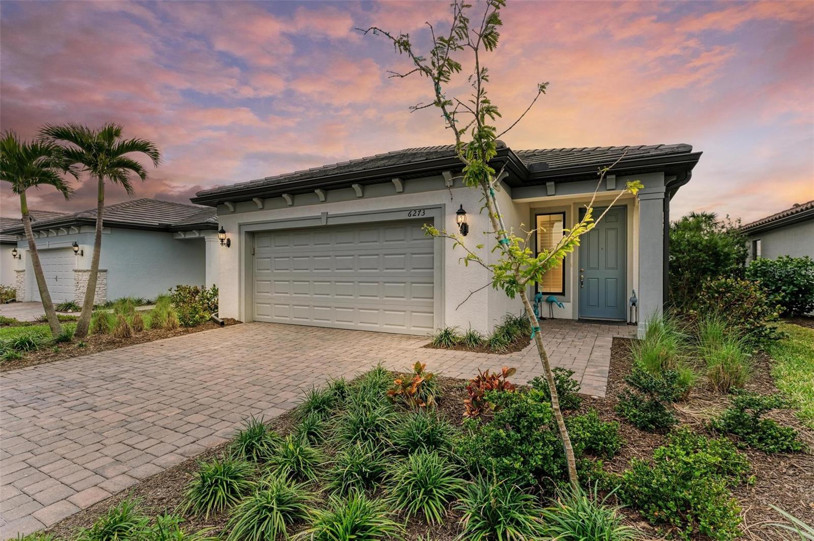 Enjoy living near the beach in the popular, recently built, beautifully designed and landscaped, gated, luxury resort-style community Talon Preserve on Palmer Ranch. Talon Preserve offers a clubhouse, serviced bar, heated pool, spa, full size gym, game arcade, ballroom, and pool-side restaurant. This is an excellent opportunity to own an attractively priced, almost new, fully upgraded, and very popular Hallmark floor plan with an extended, caged lanai and an outdoor kitchen. This 2BR + Den home sits on a spacious and private $43,000 premium homesite that offers a bright southern rear exposure, privacy, and the limited traffic that goes with living on a cul-de-sac street. The home's modern design includes large tile throughout the living area and flex room, 42-inch white shaker-style cabinets, Quartz countertops, and designer backsplash. The sizable primary suite offers 2 walk-in closets with built-in shelving and drawers, dual sinks, and a shower with frameless enclosure. Spend your Florida evenings on the spacious extended patio surrounded with luscious greenery watered with its own (owner-designed) automatic irrigation system. Enjoy al fresco dining using the outdoor kitchen with a natural gas grill and a refrigerator to prepare delicious meals. Additional Talon Preserve community amenities include 8 pickle ball courts, 2 tennis courts, and private community access to the Legacy Trail for biking, walking, and running enthusiasts. Talon Preserve is located near beautiful Suncoast Beaches (10 minutes away), gourmet restaurants, shops, historic downtown Venice, artsy downtown Sarasota, and just a short distance to the recently opened Sarasota Memorial Hospital Venice campus. Call today for your private showing!