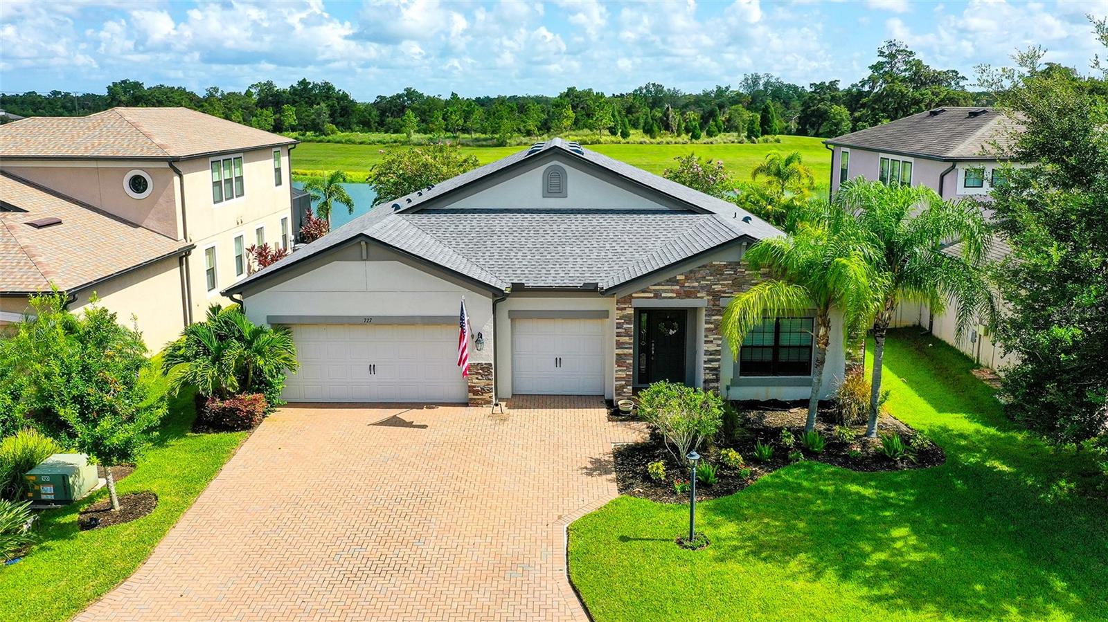 This beautiful 4 bedroom 3 bathroom home has a 3 car garage and an incredible lake and preserve view. The floor plan is very open and bright, and great for entertaining both inside and outside. Enjoy the expansive lake and preserve view from the extended covered lanai or on the outdoor brick patio. Great fishing and birdwatching from your own backyard. The kitchen is beautiful with quartz counters, wood cabinetry, stainless appliances, backsplash and under cabinet lighting. The master suite is large with 2 walk-in closets. The bathroom is very elegant with quartz counter, dual sinks, garden. tub, and large shower. The bedroom in the front of the house is currently used an an office, but all the bedrooms have plenty of space. Irrigation water included. Quick access to I-75. Close to restaurants, shopping, golf, beaches, and boat ramp. Enjoy life with all there is to do in the area with Lakewood Ranch, Sarasota, Bradenton, St. Pete, and Tampa.