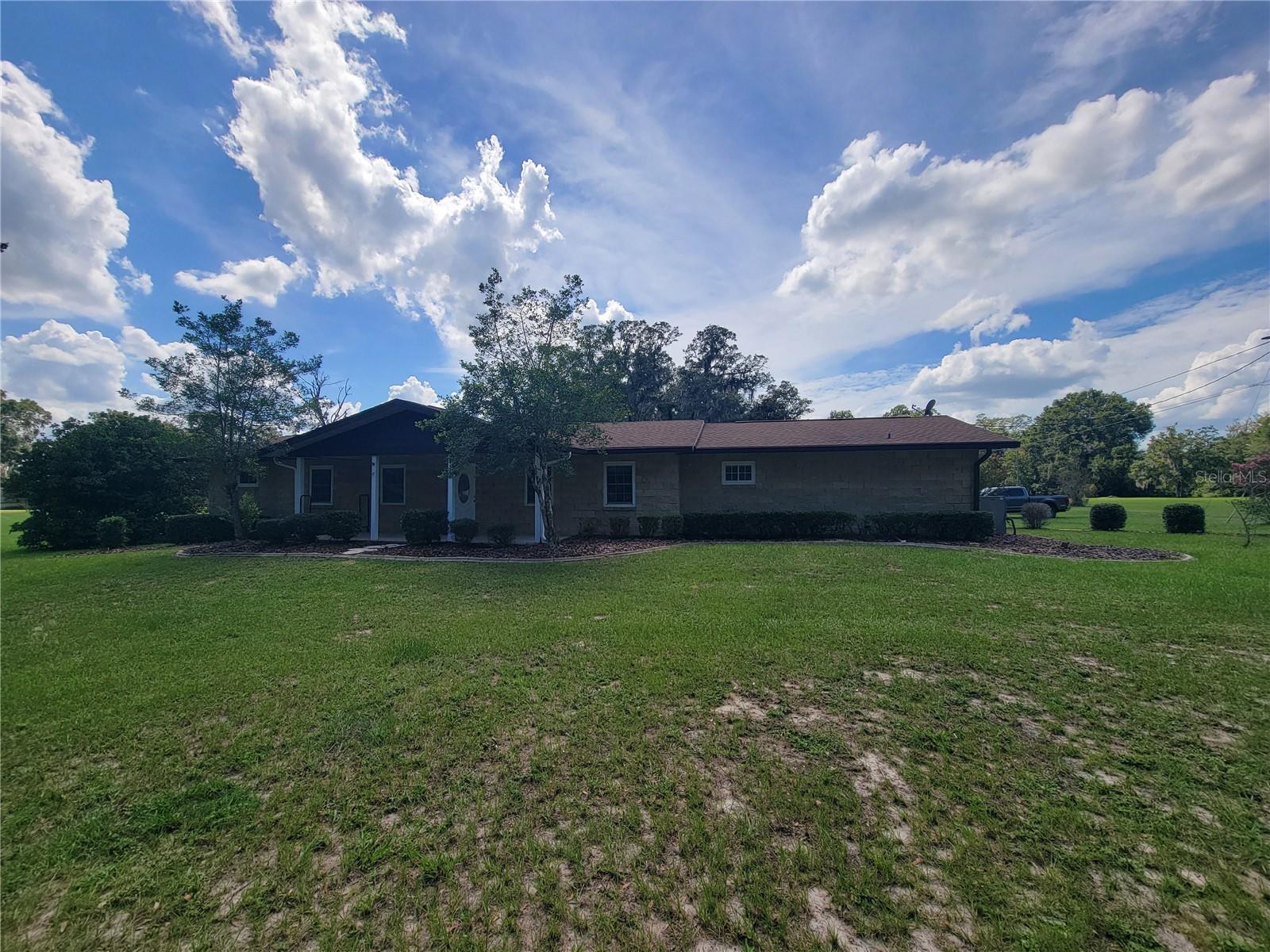 BEAUTIFUL 3/2 HOME WITH SCREENED POOL SITUATED ON 1.5 ACRES. THIS HOME FEATURES A LIVING ROOM AND FAMILY ROOM, BOTH WITH FIREPLACES AND WOOD FLOORS. LARGE KITCHEN WITH NEWER APPLIANCES AND TILE FLOORS WITH EATING AREA. SEPARATE FORMAL DINING ROOM. LARGE MASTER SUITE AND SPACIOUS EXTRA BEDROOMS. LOVELY FLORIDA ROOM LEADING TO THE TILED POOL AREA. UPGRADED WINDOWS & NICE WOOD FLOORS THROUGHOUT.2 CAR OVERHANG IN THE BACKYARD FOR CARS OR BOATS. PLENTY OF ROOM TO STORE YOUR BOATS, TRAILERS, ETC. ON 1.5 ACRES. THIS HOME IS A MUST-SEE! VERY WELL KEPT AND CONVENIENT TO ALL OF THE AMENITIES BELLEVIEW HAS TO OFFER! RENT INCLUDES POOL AND LAWN SERVICE.