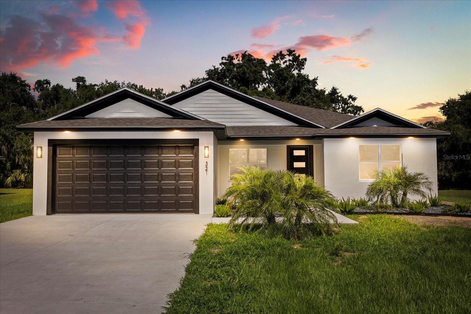 One or more photo(s) has been virtually staged. Brand-new construction on a spacious 0.44-acre lot with no rear neighbors and no neighbors on the right side, offering exceptional privacy and modern Florida living. This 4-bedroom, 3-bathroom home features an open floor plan with smooth-finished walls and ceilings, tray ceilings, and no carpet throughout. The chef-style kitchen is equipped with quartz countertops, a Samsung Bespoke refrigerator, stainless steel appliances, 42" soft-close cabinets, designer backsplash, farmhouse sink, and a large island—perfect for entertaining. Two bedrooms are private suites, including a luxurious primary with a walk-in closet and en suite bath featuring dual quartz vanities and a glass-enclosed shower. Enjoy a spacious backyard from the covered patio, ideal for relaxing or hosting guests. Additional highlights include a laundry room with built-in storage and a pet shower, paver driveway energy-efficient construction, and a two-car garage. Located in a community with an optional HOA and access to a private dock and boat launch. Schedule your private showing today!