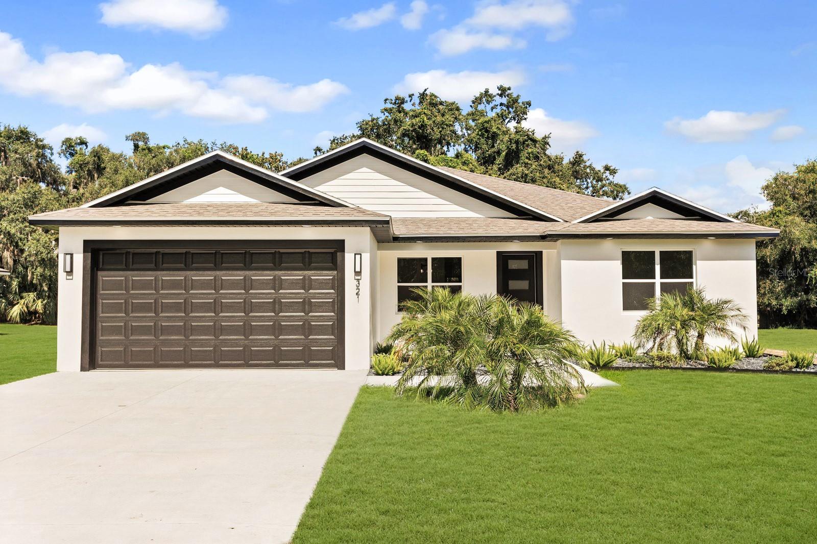 One or more photo(s) has been virtually staged. Brand-new construction on a spacious 0.44-acre lot with no rear neighbors and no neighbors on the right side, offering exceptional privacy and modern Florida living. This 4-bedroom, 3-bathroom home features an open floor plan with smooth-finished walls and ceilings, tray ceilings, and no carpet throughout. The chef-style kitchen is equipped with quartz countertops, a Samsung Bespoke refrigerator, stainless steel appliances, 42" soft-close cabinets, designer backsplash, farmhouse sink, and a large island—perfect for entertaining. Two bedrooms are private suites, including a luxurious primary with a walk-in closet and en suite bath featuring dual quartz vanities and a glass-enclosed shower. Enjoy a spacious backyard from the covered patio, ideal for relaxing or hosting guests. Additional highlights include a laundry room with built-in storage and a pet shower, paver driveway energy-efficient construction, and a two-car garage. Located in a community with an optional HOA and access to a private dock and boat launch. Schedule your private showing today!