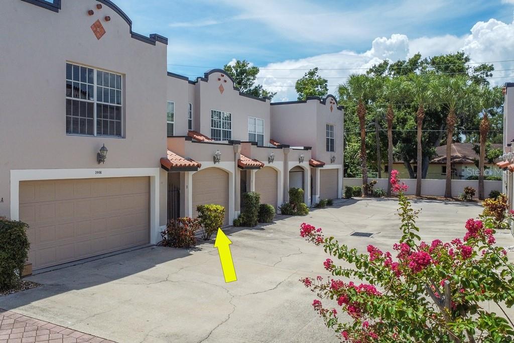 Well-maintained and updated Ballast Point 2/2.5 townhome gently lived in by original owner! First level living area is an open floor plan with newer wood floors and French door access out to the deck, which is fabricated from composite material. The kitchen features wood cabinets with crown detail, two lazy Susans, closet pantry and breakfast bar. Appliances include a new French door fridge with bottom-mount freezer, newer stove and microwave and new garbage disposal. Both bedrooms are on the second level and feature custom closets and en suite bathrooms with granite countertops and undermount sinks. There is a new fence along the rear of the property and an abundance of privacy landscaping. Blinds, rods and drapes are all included, as is the washer and dryer. The garage door was replaced in 2024; HVAC in 2018 with new coils in 2023, and new water heater in 2018. The exterior of the building was repainted in August 2025. Bayshore Palms is a gated, 20-unit townhome community which has been prudently managed over the years. Location is unbeatable: mere minutes to Bayshore linear park, downtown Tampa and St. Pete, MacDill AFB, and all major roads and shopping.