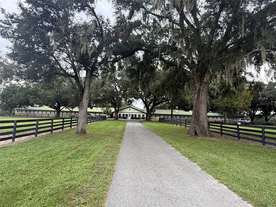 This fantastic equestrian property sits on 66+ lush acres in the heart of horse country. The property greets you with a tree lined driveway with spectacular granddaddy Oaks, the facility is complete with a 48 stall, concrete, center aisle barn, with tack rooms, storage, laundry, etc. The 3 bedroom | 2.5 bath main residence boasts a screened in pool, office, granite counter tops, stainless steel appliances, open floor plan, and more! There property also has a 4 bedroom, 2 bath mobile home for staff housing and equine amenities include: equine pool, hot walker, 4 round pens, 15+ paddocks, an all weather riding arena, and shared ownership to the 3/4 mile track.