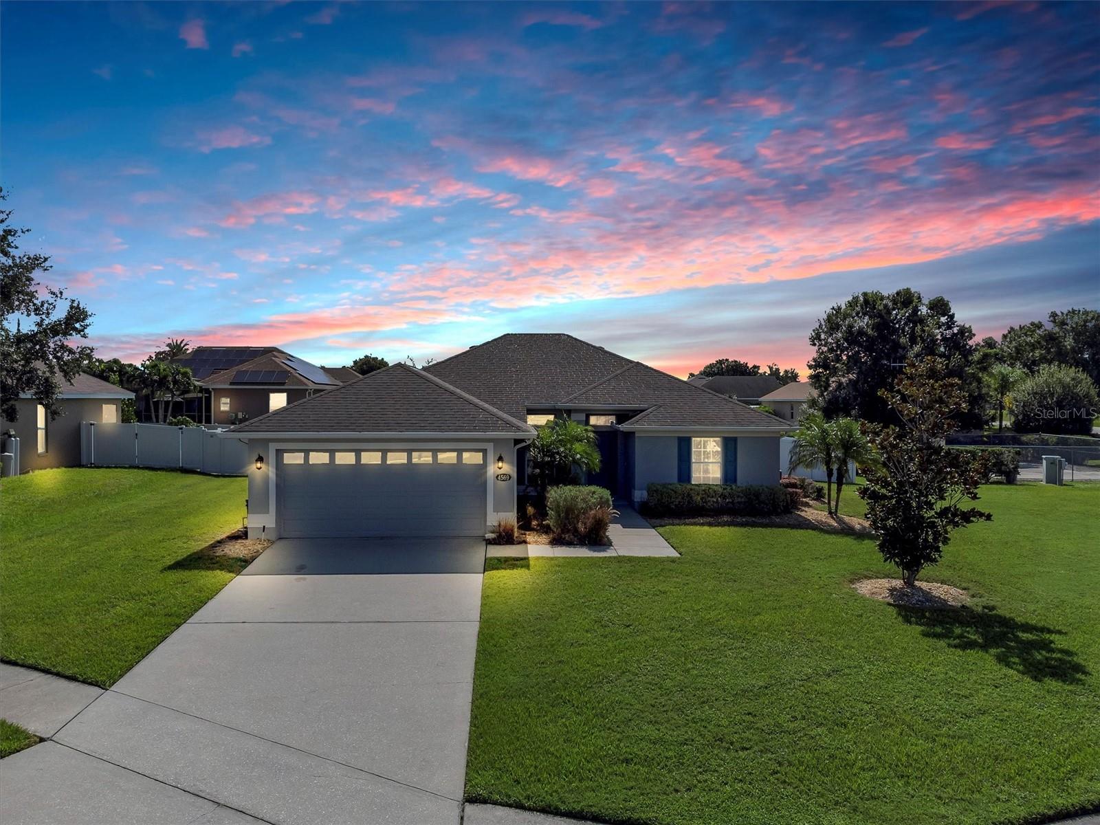 Welcome to 4569 Mandolin Blvd, a stylish and move-in ready four-bedroom, two-bathroom home sitting proudly on a gorgeous .32-acre corner lot in the heart of the sought-after gated Mandolin community. With 1,665 square feet of living space and thoughtful updates throughout, this home blends comfort, style, and functionality in all the right ways.
A brand-new roof is already scheduled for installation in September 2025, giving you peace of mind and long-term value. From the moment you pull into the driveway, you’ll notice the inviting curb appeal and wide-open green space surrounding the home, ideal for outdoor living, entertaining, or simply enjoying your own little slice of Florida.
Inside, the open layout is enhanced by vaulted ceilings, neutral paint, and durable luxury vinyl plank flooring that flows seamlessly through the main living areas. The living room, dining space, and kitchen connect effortlessly, creating the perfect setting for hosting guests or relaxing at home. The kitchen is warm and functional with stainless steel appliances, a wraparound breakfast bar, a decorative tile backsplash, and generous cabinetry and pantry space. Whether you love to cook or simply need a welcoming spot to start your morning, this kitchen delivers.
The split-bedroom floor plan ensures privacy and flexibility. The primary suite is spacious and features a large walk-in closet and updated ensuite bath with dual vanities topped with quartz counters, matte black fixtures, and a bathtub/shower combo. Three additional bedrooms provide flexibility for guests, family, or a home office, and the second full bath has also been tastefully refreshed.
Step out back into your private retreat where a screened-in lanai with a ceiling fan overlooks a massive, fully fenced backyard. The vinyl privacy fence creates the perfect outdoor space for pets, kids, or weekend barbecues, with plenty of room left for a pool, play set, or garden oasis. A double gate also allows easy access for storing recreational equipment or trailers.
Additional features include a dedicated laundry room with LG front-loading washer and dryer, updated light fixtures and ceiling fans throughout, a modern water filtration system, and a two-car garage. This home has been lovingly maintained and includes key updates that make it truly move-in ready.
Located just minutes from shopping, dining, Legoland, and major routes like US-27 and Cypress Gardens Blvd, this home offers both tranquility and convenience in one of Winter Haven’s most popular communities. If you’re looking for a home on a corner lot with privacy, updates, and room to grow, 4569 Mandolin Blvd is ready to welcome you home. Schedule your showing today before this one is gone.