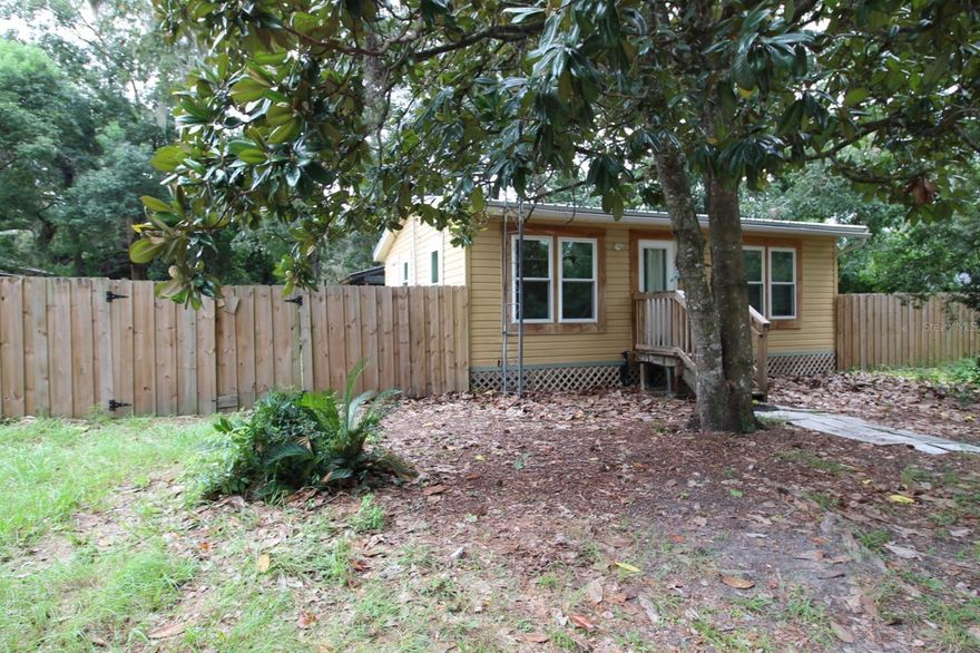 Tucked away on a quiet street in the heart of a charming small town, this cozy home offers the perfect blend of comfort and convenience. The inviting living space features an open layout, with plenty of natural light that makes it feel bright and airy. The kitchen is efficiently designed, making meal prep a breeze. Step outside to discover a private, fully fenced backyard—an ideal spot for recreation and relaxation. Cross fencing offers an opportunity to grow your own produce, a brood of chickens, and other creatures you want to include in your mini farm.  A large covered patio makes for a great entertainment space. A 10x20 loft barn is ready for utility hook ups and hobby benches. Just a short walk to local parks, public library, and weekly Farmers Market. Easy 20-25 minute commute to Gainesville, UF, UF Health, VA Hospital, Butler Plaza, and Celebration Pointe. 40 minutes to Gulf fishing in Cedar Key. Home should qualify for conventional, FHA, VA & USDA