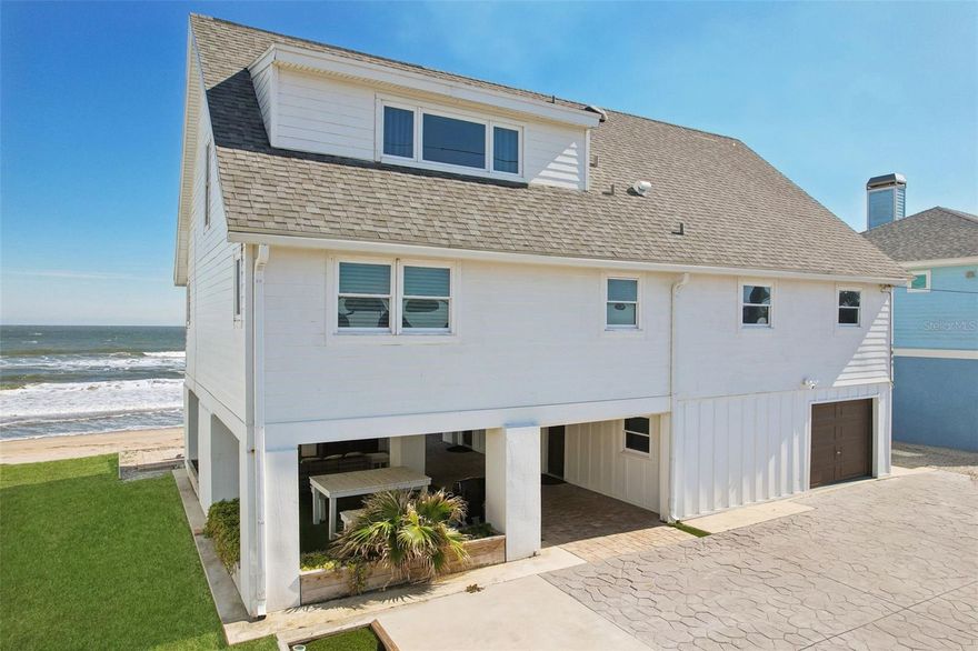 Welcome to oceanfront bliss! This stunning coastal retreat offers unparalleled views, luxurious comfort and versatile living spaces. Thoughtfully renovated and immaculately maintained, this turnkey property is ideal for family gatherings, business retreats or as a potentially lucrative vacation rental investment. The bright and airy main living space features vaulted ceilings with exposed beams, an open-concept layout and floor-to-ceiling windows that frame breathtaking ocean views. The gourmet kitchen boasts modern appliances, a large dining table, and seamless flow into the spacious living area, ideal for entertaining or relaxing. A generous deck spans the length of the home, providing ample space for alfresco dining, lounging and soaking in the coastal ambiance. Accommodating up to 13 guests, the home features beautifully appointed bedrooms that exude comfort and tranquility. The property also includes a private ground-level suite with its entrance, offering flexibility for guests or owners. This cozy retreat features a spacious bedroom with a king-sized bed, a sitting area with a sofa and TV, and a well-appointed en-suite bath. Stylish details such as shiplap accents, terracotta tile flooring and contemporary lighting create a welcoming atmosphere. Outdoor living is a dream, with direct beach access just a short distance away, a covered ground-level patio ideal for grilling and a relaxing Jacuzzi overlooking the water, providing an ultimate spot to unwind. Ample parking and low-maintenance landscaping ensure convenience and ease. Just 10 minutes from historic downtown St. Augustine and 20 minutes from Jacksonville, this home offers the ideal balance of tranquility and accessibility. Enjoy world-class dining, shopping and attractions while savoring the peace and privacy of your oceanfront oasis. A successful vacation rental, the home is being sold fully furnished, offering a seamless transition for new owners. Whether you're looking for permanent residence, a vacation getaway or a turnkey investment property, this coastal gem delivers everything you need. Schedule your private tour today and experience the magic of oceanfront living.