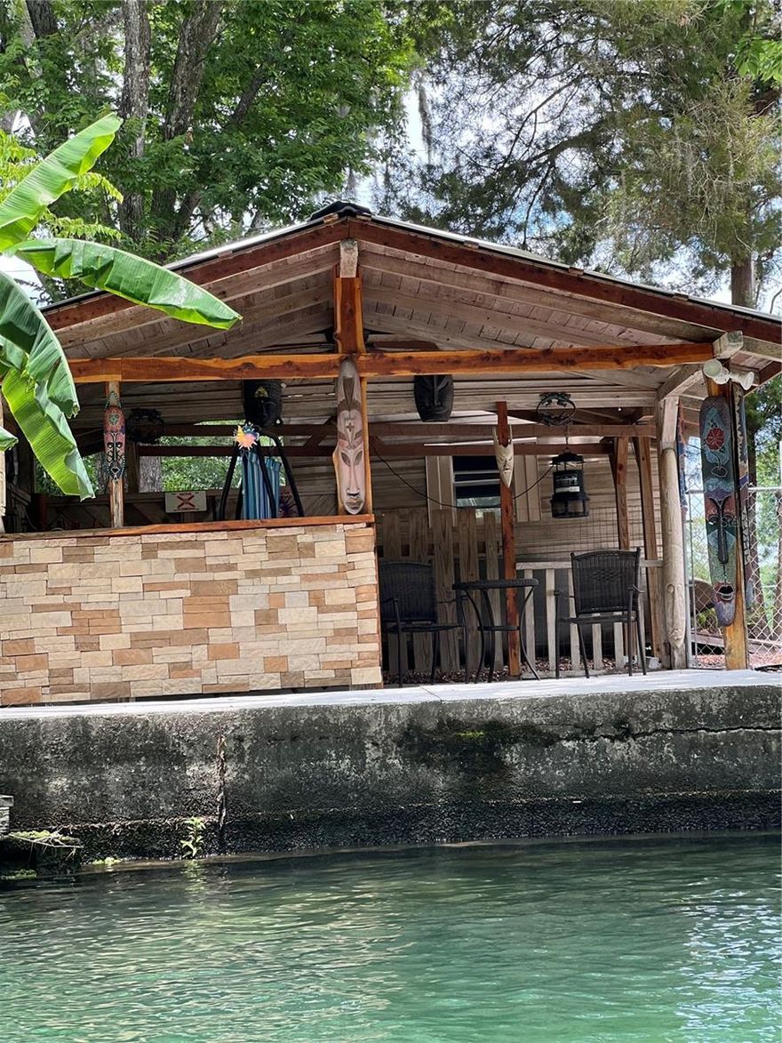Welcome to your waterfront paradise on the Weeki Wachee River! This charming property features a delightful waterfront tiki bar with a covered roof, perfect for entertaining and relaxing by the water. Enjoy 50 feet of seawall and convenient concrete stairs that lead directly into the river, making kayaking and exploration effortless. With a private preserve across the river, you'll enjoy unobstructed views and guaranteed privacy. The lot, measuring approximately 50 by 102 feet, offers ample space to build your dream getaway. Plus, the consistent 72-degree water temperatures make it an ideal summer retreat, just a short drive from the airport. Additionally, the adjacent lot is also available for sale, offering even more possibilities to expand your waterfront haven. A recent soil test has been completed, along with a survey that includes elevation details, ensuring peace of mind for future development. Don’t miss this unique opportunity to own a piece of paradise!