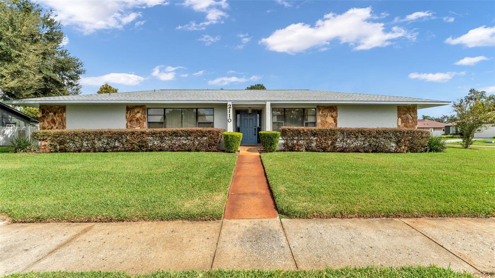 Located on a generous corner lot in the sought-after Walden Lake community, this spacious 3-bedroom, 3-bath home—with a dedicated office—features a flexible floor plan, an oversized yard, and unbeatable value. With a large front lawn and a wide backyard, there’s plenty of room to play, garden, or simply relax outdoors. A charming sidewalk leads you to the front door and into an open foyer, where natural light pours through a triple-panel window in the front living area, creating a warm and airy welcome.
Toward the back of the home, the family room centers around a beautiful stone fireplace, full of character and charm. Glass sliders open to the enclosed patio, creating a quiet spot to unwind or entertain year-round. The dining room features a cozy accent wall, wood shutters, and great natural light—perfect for everyday meals or holiday gatherings. The kitchen is functional and inviting, with wood cabinetry, tile flooring, and a cheerful breakfast nook surrounded by windows. A built-in desk adds bonus space for work, homework, or meal planning.
The primary suite is generously sized and thoughtfully designed, with dual sinks, a walk-in closet, and two access points to the ensuite bath. Two additional bedrooms are comfortably carpeted, and one has direct access to the second full bathroom. The dedicated office provides flexibility for remote work, hobbies, or even a fourth bedroom conversion. You'll also love the convenience of the indoor laundry room with a utility sink and shelving, and a side-entry two-car garage that includes a rare bonus: a third full bathroom.
This home is priced to reflect its need for cosmetic updates, making it an ideal opportunity to add your personal touch and build equity over time. Major items like the roof and A/C have already been updated, so you can focus on the fun stuff. And with Walden Lake’s community amenities—pool, playground, tennis courts, and walking trails—you’ll enjoy a neighborhood lifestyle that’s hard to beat.
Don’t miss your chance to own a home with great bones, generous space, and incredible potential in one of Plant City’s most desirable neighborhoods. Schedule your showing today!