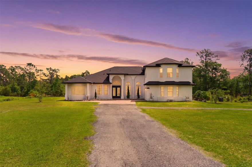 Escape to Wedgefield, where 3.25 acres of serene, A-2 zoned rural living meets city convenience with NO HOA. A grand driveway leads you to a private courtyard—the perfect front-row seat for Cape Canaveral rocket launches. Inside, a chef’s kitchen serves as the heart of the home, featuring a massive Quartz island, dual pantries (including a baker’s pantry), and a built-in coffee and wine bar.

The traditional split floor plan keeps all bedrooms on the main level for ultimate privacy, with a massive upstairs bonus room awaiting your vision for a cinema or private retreat. Enjoy the bonus room with access to the master as an office or a nursery. There is a mother-in-law suite and a separate  detached 2-bedroom, one bedroom  guest house that could provide a true multi-generational retreat or potential rental income. Step outside to a backyard oasis featuring a waterfall pool with grotto seating and a toddler splash pad. With dual paid off solar systems, 2 EV chargers, and a prime location—20 mins to the beach/airport and 30 mins to Disney—this is more than a home; it’s a destination. The home is fully furnished and the furniture is negotiable. Schedule your showing today for this one of a kind gem!