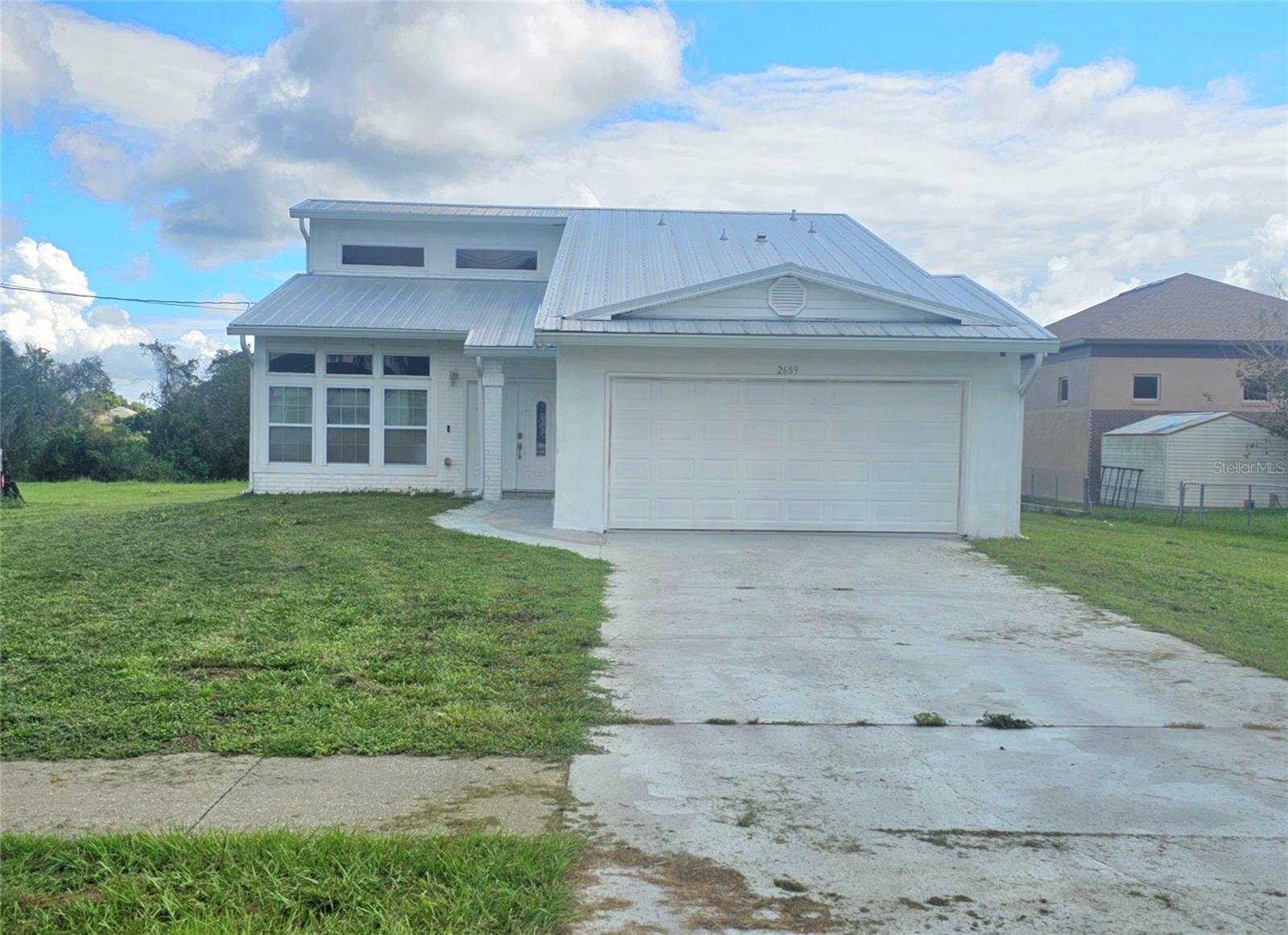 This home sits on a spacious .53-acre lot with direct water access, offering the perfect space and versatility to design your dream residence or make a smart investment. Key Features: Recent updates: A/C (2021), new roof (2021), new septic tank, remodeled bathrooms. Safety & comfort: Front hurricane-impact windows. Spacious layout: Bright, open living room with high ceilings and a loft on the second floor. Outdoor connection: Sliding doors from both the living room and primary bedroom lead to the patio. Renovated bathrooms on the second floor 2-car garage. Room to Personalize: The first floor is partially remodeled, ready for you to design a modern kitchen, install new flooring, or refresh the living spaces with your personal touch. Outdoor Living: Large backyard with direct water access—perfect for fishing, kayaking, or simply relaxing with incredible views. Plenty of room for a pool, garden, or entertainment area.
55 minutes to the park, this property is ideal for families, nature lovers, or anyone seeking space, tranquility, and convenience.