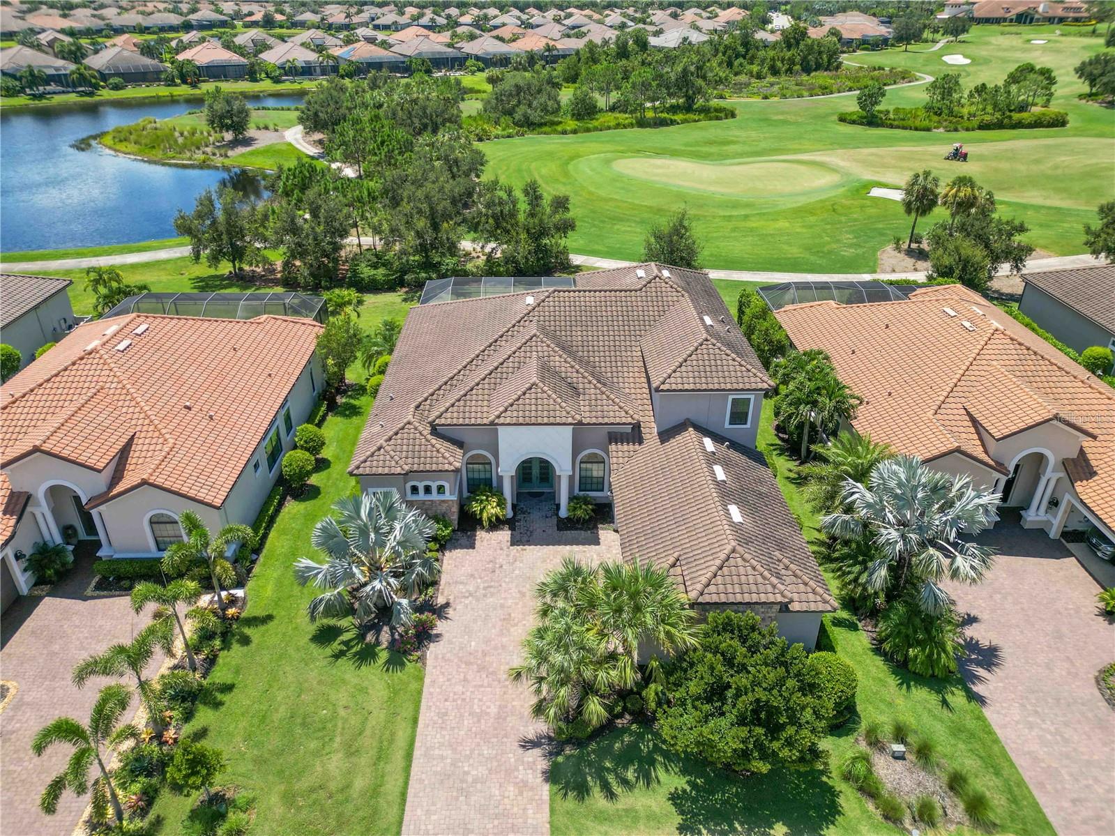 One or more photo(s) has been virtually staged. The Best Deal in Esplanade— Luxury Golf Estate in Esplanade with Unrivaled Views and Impact Windows!
This golf-deeded masterpiece sits on Esplanade’s premier Hole 1 green, delivering sunset water and course views from your lanai. Impeccably refreshed inside and out, the home offers 4 bedrooms, 4 full baths, 2 half baths, an office, formal dining, and an upstairs flex space.
A chef’s kitchen commands attention with quartz island, premium stainless appliances, walk-in pantry, and custom cabinetry. The primary suite is pure indulgence—private lanai access, spa-style marble bath, and expansive closets. Every guest suite has a private bath.
Pocket sliders open to a resort-caliber lanai with heated pool, spa, outdoor kitchen, bar seating, and SONOS sound. Hurricane windows, 4-zone AC, new tankless water heater, and other high-end upgrades ensure comfort and peace of mind.
Enjoy Esplanade’s exclusive golf, tennis, pickleball, bocce, pools, fitness centers, Bahama Bar, and Culinary Center—all within Lakewood Ranch, America’s #1 master-planned community.
This is more than a home—it’s a front-row seat to the Esplanade lifestyle.
Don’t miss this new opportunity at such a great price in this extraordinary neighborhood.
