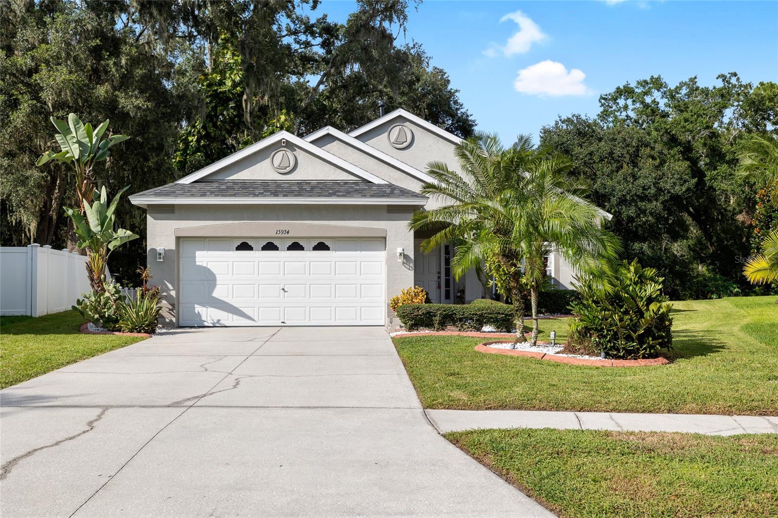 Your private backyard oasis awaits — no rear neighbors, serene conservation views, and a brand-new roof in 2025! This beautifully maintained and tastefully renovated 3-bedroom, 3-bath, 2-car garage home offers 1,501 sq. ft. of comfortable living space in the highly desirable Deer Park Preserve community. The home flows beautifully with abundant natural light, creating a bright and welcoming atmosphere throughout, and is located in a NON-FLOOD ZONE — high and dry for peace of mind!
Step inside to a large, light-filled living room with a beautiful picture window overlooking the front yard, creating a warm and inviting first impression. From here, the home flows effortlessly into the kitchen and dining area, making it easy to move between relaxing, cooking, and gathering with friends and family. The kitchen offers gorgeous granite countertops, white shaker cabinets, stainless steel appliances, and a gas stove. The dining space leads directly out sliding glass doors to your oversized backyard retreat — a .28-acre lot with expansive conservation views, no rear neighbors, a large patio, and a fire pit — perfect for enjoying peaceful evenings with friends and family around a bonfire, with plenty of room for activities in your own private backyard.
The primary suite features a large walk-in closet and a private en-suite bath with a double vanity topped with sleek black granite counters. Two additional bedrooms share a nicely appointed guest bath, each with generous closet space for ample storage. Beautiful laminate flooring runs throughout all living areas, adding warmth and cohesion to the home’s design.
Additional highlights include an inside laundry room, extended driveway, and easy access to I-275, downtown Tampa, USF, shopping, and dining. With no CDD fees and low HOA fees, this move-in-ready home offers the perfect combination of privacy, space, and convenience. Schedule your showing today and make your backyard dreams a reality!