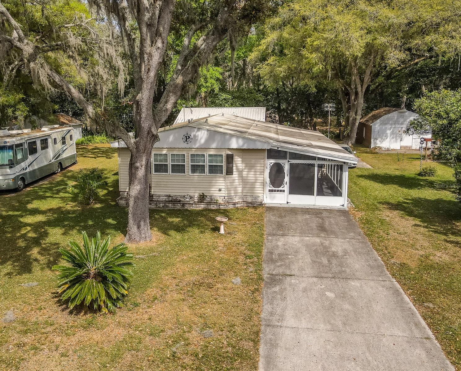 BACK ON THE MARKET DUE TO BUYERS FAILURE TO PERFORM!! You Own The Land !!! No Lot Rent.. Pictures Do Not Do Justice to this One of a Kind Home!! Located on a Private Road in a Small Sought After Neighborhood. This Home Has Been Meticulously Maintained and Upgraded. There is a Room For Every Need !!! Situated on a .24 Beautiful Lot This 2 Bedroom, 2 Full Bath W/ Potential for a 3rd Bedroom is Currently Being Used as a Family Room. Kitchen W/ Pantry, Custom Countertops, New Can Lighting, Built In's and Newer Stainless Appliances. Huge Living Room W/ Closet, Plantation Blinds, New High End Carpet W/ Extra Padding. Cozy Dining Area W/ Wainscoting and Beautiful Chandelier. Master Bedroom W/ Walk In Closet, Upgraded Master Bath, Oversized Tub and Built in Cabinets for Storage. 2nd Bedroom W/ Upgraded Bathroom. 26x12 Family Room/ Bonus Room W/ Separate Office opens up to a 17x11 Screened in Front Porch W/ Custom Made Doors That Can be Opened for a Carport. Huge Block Garage/ Workshop W/ Newer Garage Door Opener, 2019 Metal Roof Over, Sink, Electricity and a Finished 14x10 MAN CAVE !! There is a Separate Shed That Can Be a She Shed or Craft Room. Home has Lifetime Rubber Roof, Upgraded Thermal Windows, Insulation, and Interior Doors. 2009 Septic System. LOW HOA of $184 a Year Includes Trash and Clubhouse Maintenance. Bring Your Boat, RV, and Golf Cart!!! You Own The Land !! 55 and over Community