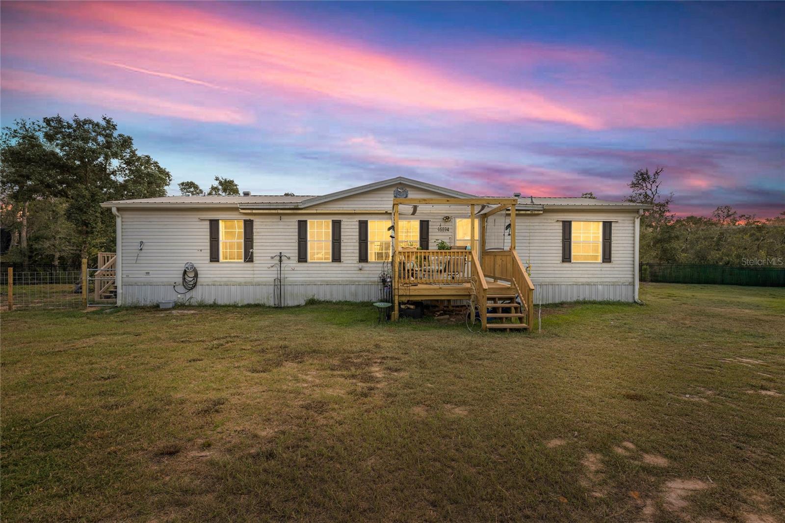 Escape to peace and privacy in the heart of the Ocala National Forest. This spacious 3 bedroom, 2 bath doublewide (1,534 sq. ft.) sits on a fully fenced double lot (.43 acres) with 160 feet of road frontage, making it an ideal retreat or investment property. Interior updates include fresh paint, new carpet in the master, updated bathrooms, and a split-bedroom floor plan with an open great room, dining, and kitchen with breakfast nook. The master suite features a walk-in closet, jetted tub, and separate shower, while bedroom two also offers a walk-in closet. Recent improvements include new fencing, brand-new front and side decks, and a new water heater in 2025. Surrounded by trees and nature, this property is perfect for anyone seeking a quiet lifestyle, a weekend getaway, or an affordable rental opportunity.