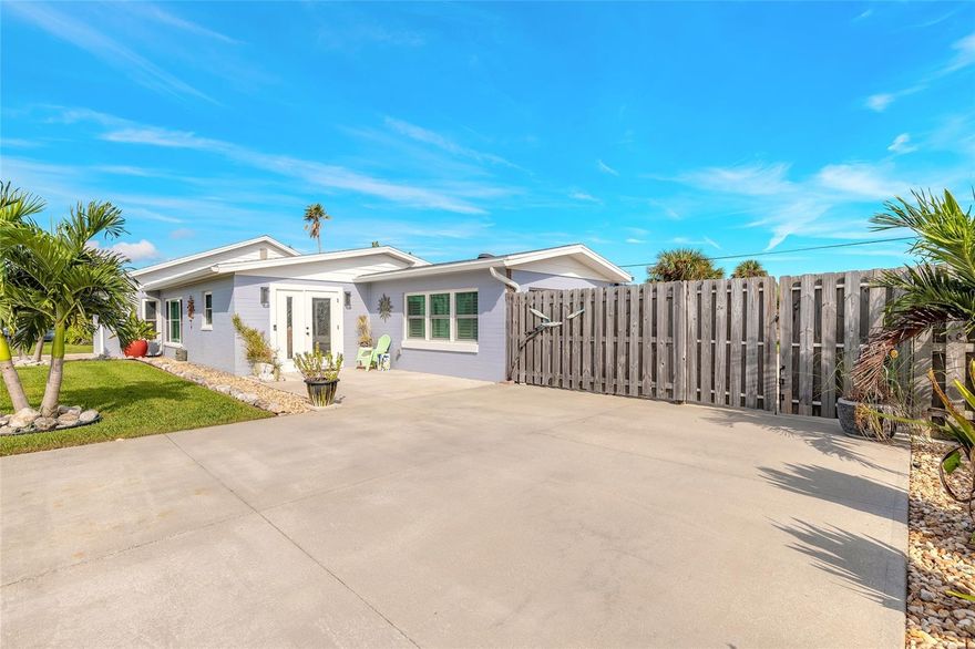 WOW! Are you dreaming of living 4 houses away from the Atlantic Ocean? Swimming in your own pool? Star gazing from your spa? Parking your boat, trailer or small RV behind a privacy fence? No HOA to answer to? Then this TURNKEY home is for you! Updated & meticulously maintained, this 2 beds & 1 bath beach house has an open kitchen with Hickory cabinets & quartz counter tops, eating nook, dedicated coffee bar, movable matching island, tons of storage, wide plank tiles (no carpeting),inside laundry, Hurricane front door and most windows. The open Family room features a nicely appointed stone wall, plenty of windows for a bright & airy atmosphere. The bathroom has also been updated. The second bedroom is currently being used as an office but has closets, windows & doors. The small garage will fit a motorcycle or a small work out area. That's just the inside! The back & side yards are absolutely an oasis for relaxation. The pool & spa are HEATED & SALT WATER, surrounded

by recently cleaned pavers. A NEW hot & cold water outdoor shower, pool pump, NO SEE UM screens and tension straps as well as HVAC system all replaced in 2025. This large property comes with a large shed, firepit, propane tank (rented),wonderfully manicured but easily maintained Florida garden all within a privacy fence. Seller has also had a 4 point and full house inspection completed to ensure this beach beauty is ready for you to walk in and just start enjoying your Florida life!
Roof 2015 Certified 2025
HVAC 2025
HWT 2015 Inspected 2025
Septic installed 2013 cleaned regularly latest 2025
Furniture is negotiable
Art in barn door, Day bed, flower pots & "head" planters in front do NOT convey
TV in Primary DOES convey