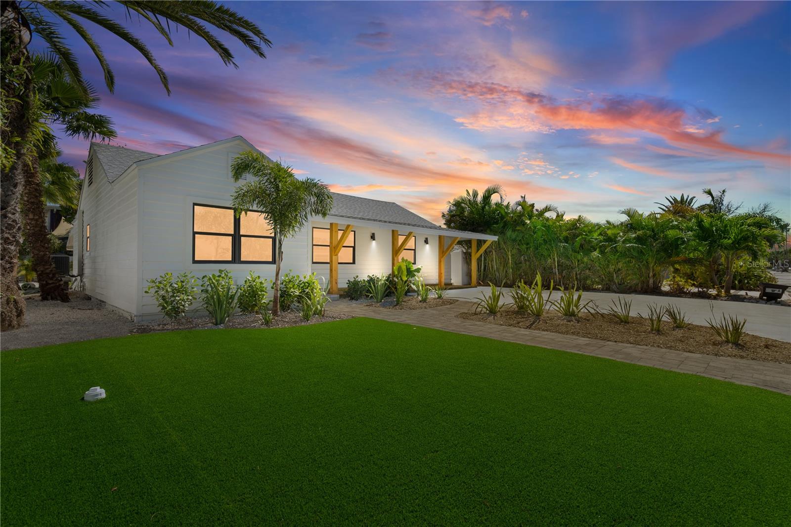 ABSOLUTELY STUNNING & RECENTLY renovated! This 3 bed 2 bath single story home is located only 1.5 blocks from the gulf in St Pete Beach (on the west/beachside not intercoastal)! This home has been very thoughtfully and beautifully designed & FULLY updated, it includes 1750+ sq ft, large backyard with LOW maintenance artificial turf and amazing tropical landscaping. Fully permitted improvements include impact doors and windows, roof replacement, full house electrical rewire & plumbing system replacement, chevron pattern plank luxury vinyl floors, and new insulation. The kitchen boasts lovely quartz countertops, a large 10 foot island, high quality white shaker cabinets, an open floating shelf layout, and new stainless steel appliances. Bathrooms will turn heads with floor to ceiling tile, bluetooth equipped exhaust fans with speakers, custom shower glass, & new fixtures, high ceiling with a skylight above the master shower and the elegant free-standing tub. In the spacious primary bedroom, enjoy separate his & her closets and laundry just steps away (new stackable washer/dryer). Moving to the large family room is the ULTIMATE entertaining space with a bumped out TV wall, electric fireplace, bar, and outdoor patio access. The AC and ducts have also been fully replaced and condenser has been lifted to new code. The backyard is a show stopper with a house-width covered patio/deck, rebuilt railings, and lots of privacy as you look out onto the LARGE fenced in & open backyard PERFECT for entertaining & playing (note plenty of room for a pool & electricity is coming from underground) enjoy your private fenced in oasis with low maintenance landscaping including artificial turf, oyster shell beds, and tropical palms/plants including an irrigation system. The front of the home features an inviting covered porch the with beautiful pine wrapped beams and pavers - . On the side of the house, you have a covered storage area and plenty of room for golf cart parking. This block of 77th Ave is quiet, family friendly, and charming with views of the intercoastal but what makes it unique is you’re still close to “the action” just a few blocks away from some of the best restaurants, coffee shops, bars, breweries, & retail in the area. North of the 75th & Gulf intersection means less noise and traffic versus to the South - and West of Gulf Blvd means you’ll enjoy easier & safer beach access and notice more higher end residences and new builds. The area’s best beach, Upham Beach, is an easy golf cart, bike ride, or walk away and booming downtown St Pete is 15-20 minutes and TPA Airport is 35 minutes (25 miles). This is an incredible opportunity to live the Florida beach lifestyle!!