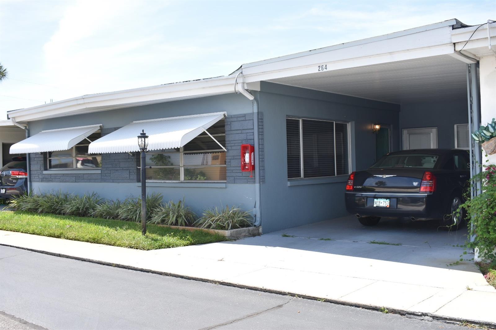 Absolutely beautiful 2 bedroom 1 1/2 bath Villa in Shangri La, a 55+ community in the heart of Largo. This property was remodeled in 2019, with a new roof, new HVAC, hot water heater, kitchen and bathrooms. Open spacious kitchen with SS appliances and shaker cabinets. Large dining room, indoor washer/dryer, and a large carport right outside your door! Shangri La offers a Club House, heated pool, shuffle board, gas grills and picnic tables. Non evacuation zone and yet close to the beach and shopping!