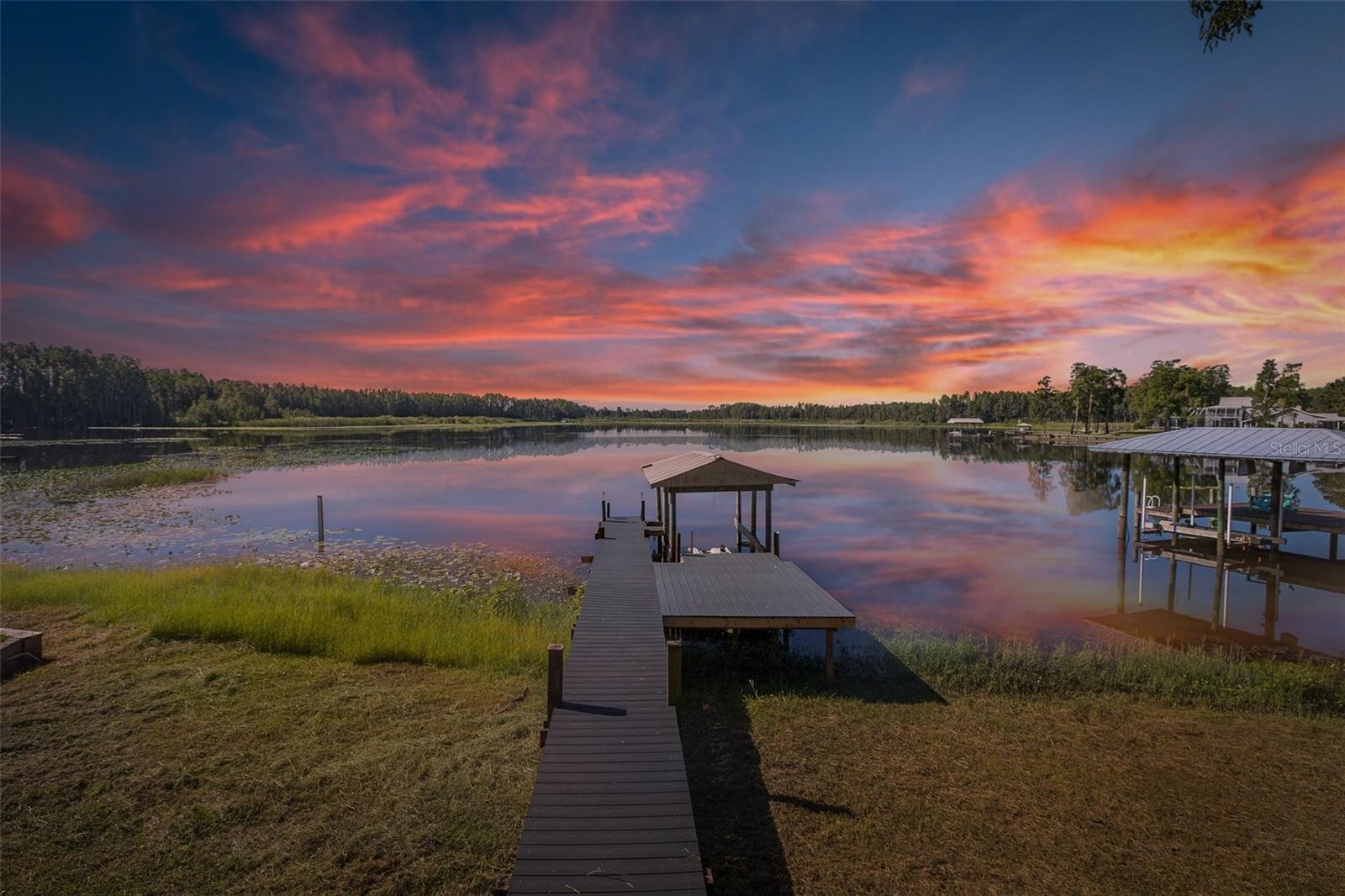 Welcome to 1850 Daiquiri Lane – Lakefront Paradise on Ski-Size Bird Lake. Discover the perfect blend of serenity and convenience in this beautifully updated lakefront home, ideally situated on the shores of private, ski-size Bird Lake. Whether you love skiing, fishing, kayaking, jet skiing, or tubing, this property offers endless opportunities for fun and relaxation. Located on just over half an acre on a quiet, private street, the home offers more than 2,000 square feet of living space with room to expand. Step inside to an open and airy floor plan designed for effortless Florida living. The interior was remodeled in 2017, featuring a chef’s kitchen with custom cabinetry, quartz countertops, Frigidaire Stainless Steel Gallery appliances, and ceramic wood-look plank flooring throughout. The bathrooms have been tastefully updated, and additional upgrades include a new roof and front door in 2017, new HVAC and double-pane insulated windows in 2016, and fresh interior and exterior paint. Enjoy peaceful mornings sunrises and glowing sunsets from the expansive 22' x 28' lanai and screened porch overlooking the lake. The property is fenced and gated, with an electric entry gate and three double-wide access gates on either side of the home and driveway. There is also a covered RV carport with 50 AMP service—perfect for storing your RV, boat, or other lake toys. With no HOA, no flood insurance required, and no deed restrictions, you’ll have the freedom to live your lifestyle your way. Only 25 homes enjoy full ski access on Bird Lake, and opportunities like this are rare. Centrally located near SR 54, US Hwy 41, Dale Mabry Highway, the Suncoast Parkway, and I-75/I-275, this home is just minutes from Wiregrass Mall, Tampa Premium Outlets, top dining destinations, and Tampa International Airport. This is more than just a home—it’s your gateway to the ultimate Florida lakefront lifestyle.